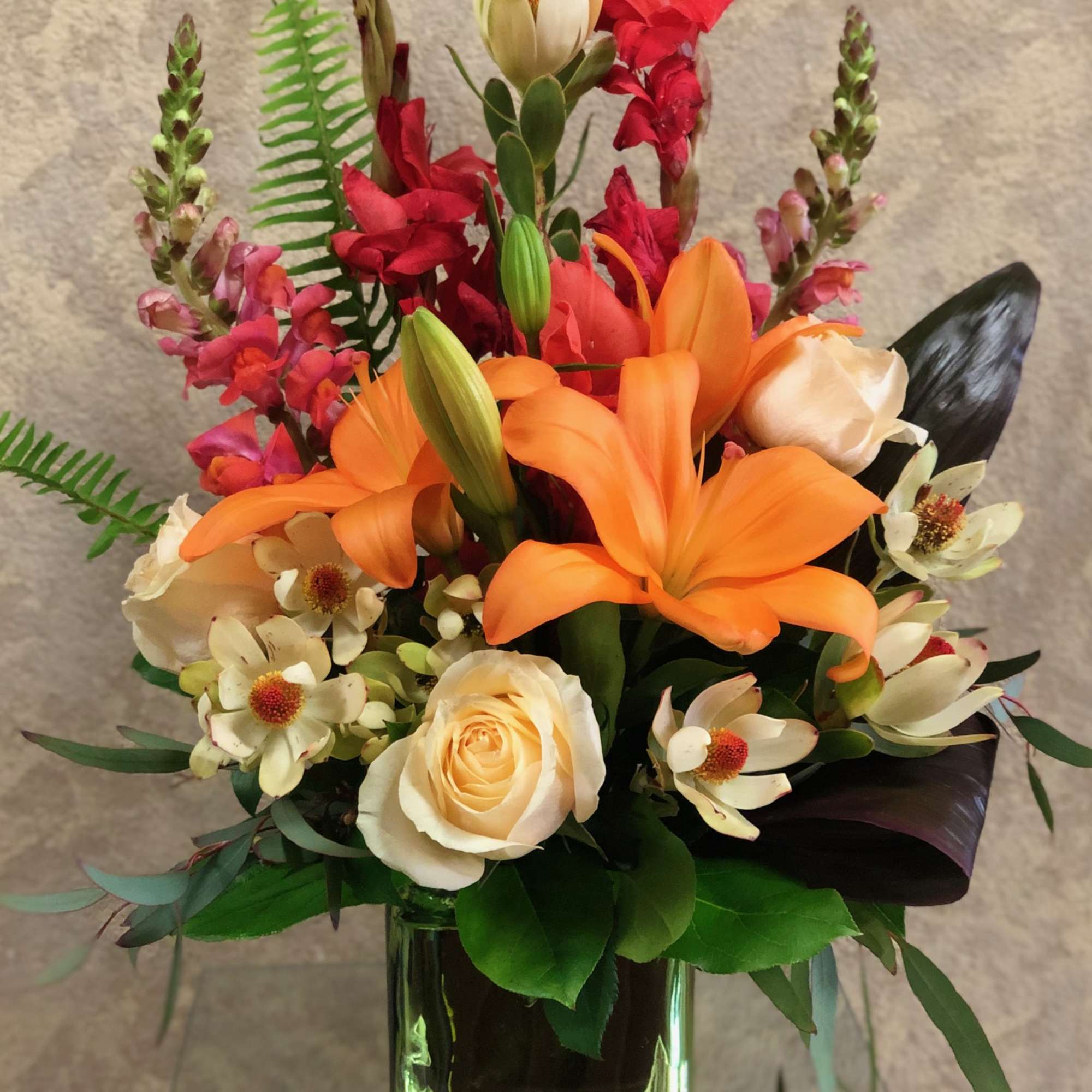 A beautiful safarian sunset with Orange Lilies, Cream Roses, Snapdragons, Gladiolas, and, photo 2 of 3