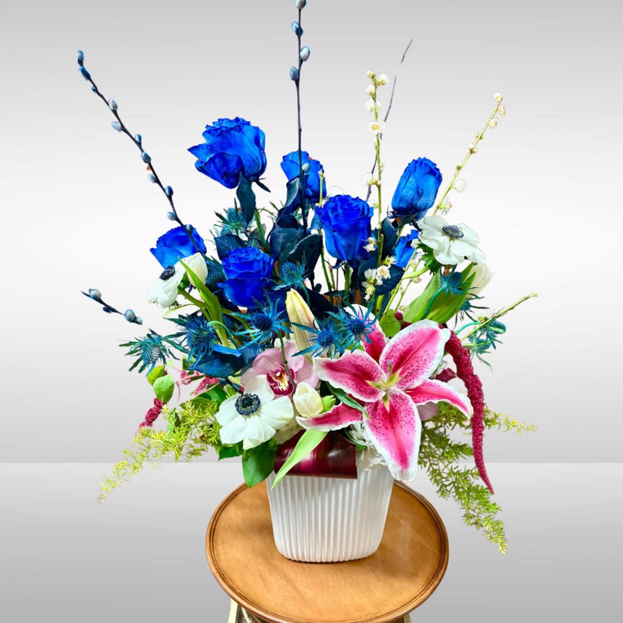 Recipe: Blue Roses, White seasonal anemones, Stargazers, Amaranthus in a tall, white, photo 2 of 3