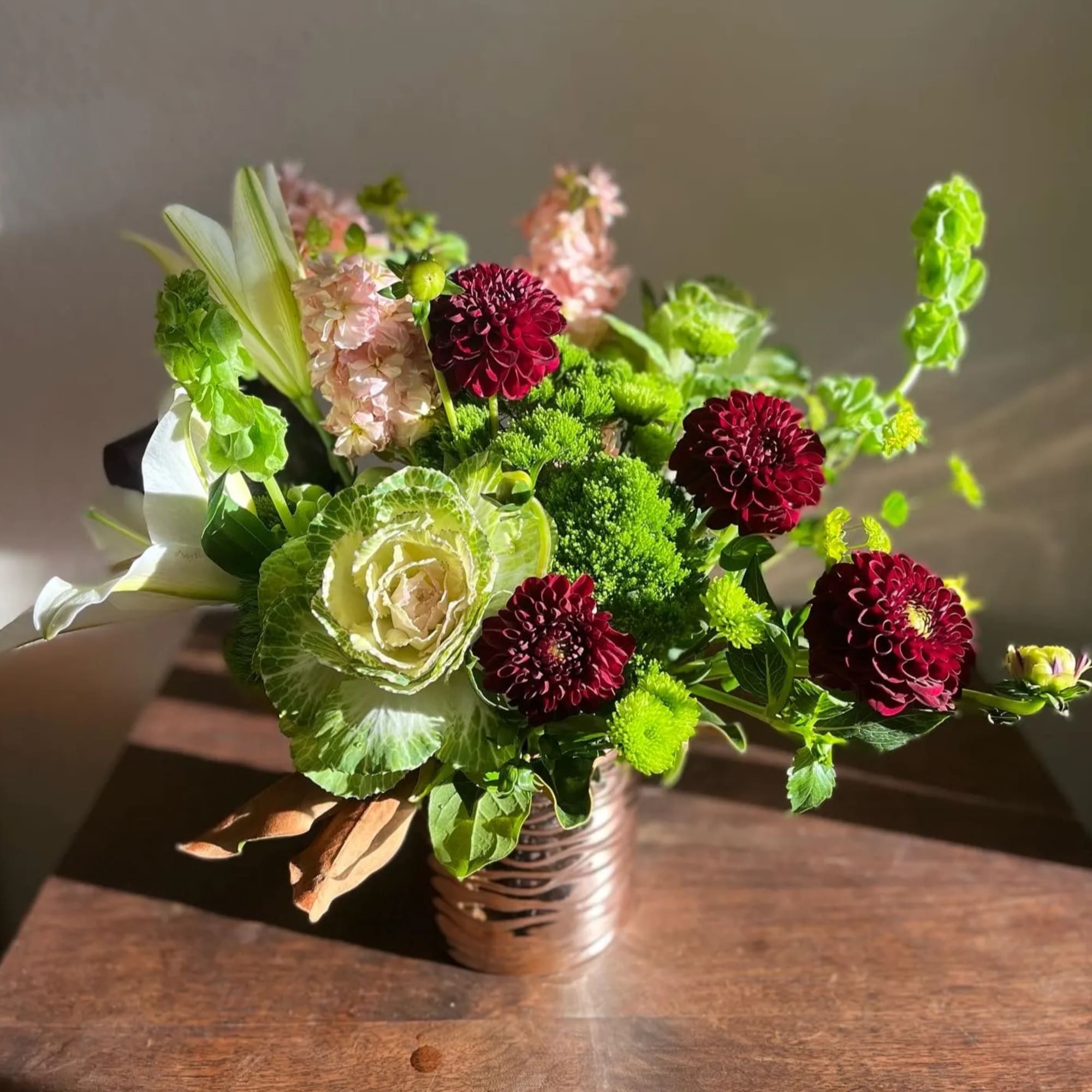 This designs has shades of greens, reds, and pinks that will bring