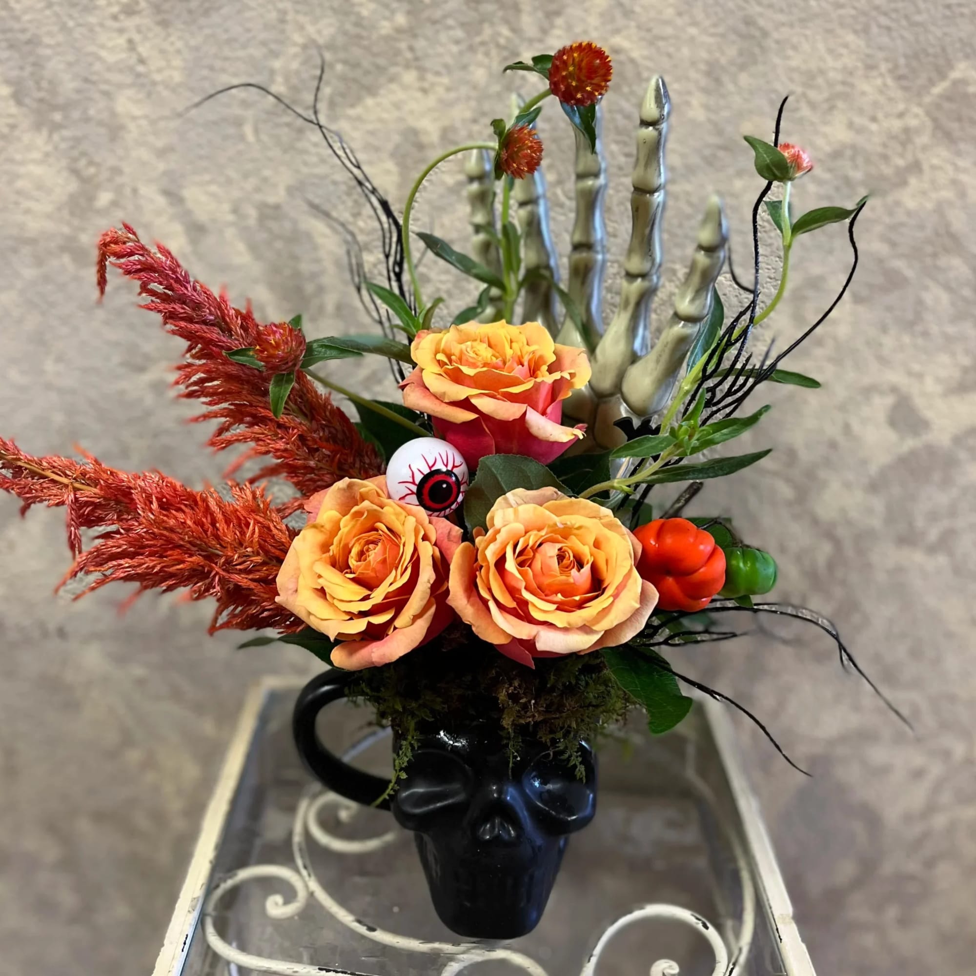 Type of Flowers: Orange Roses, Amaranthus, Branches, and moss with halloween accents