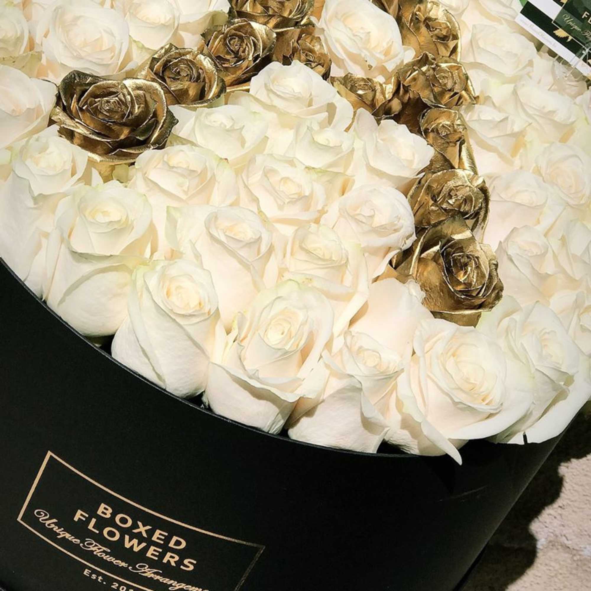 Boxed bouquet of white roses with metallic gold roses