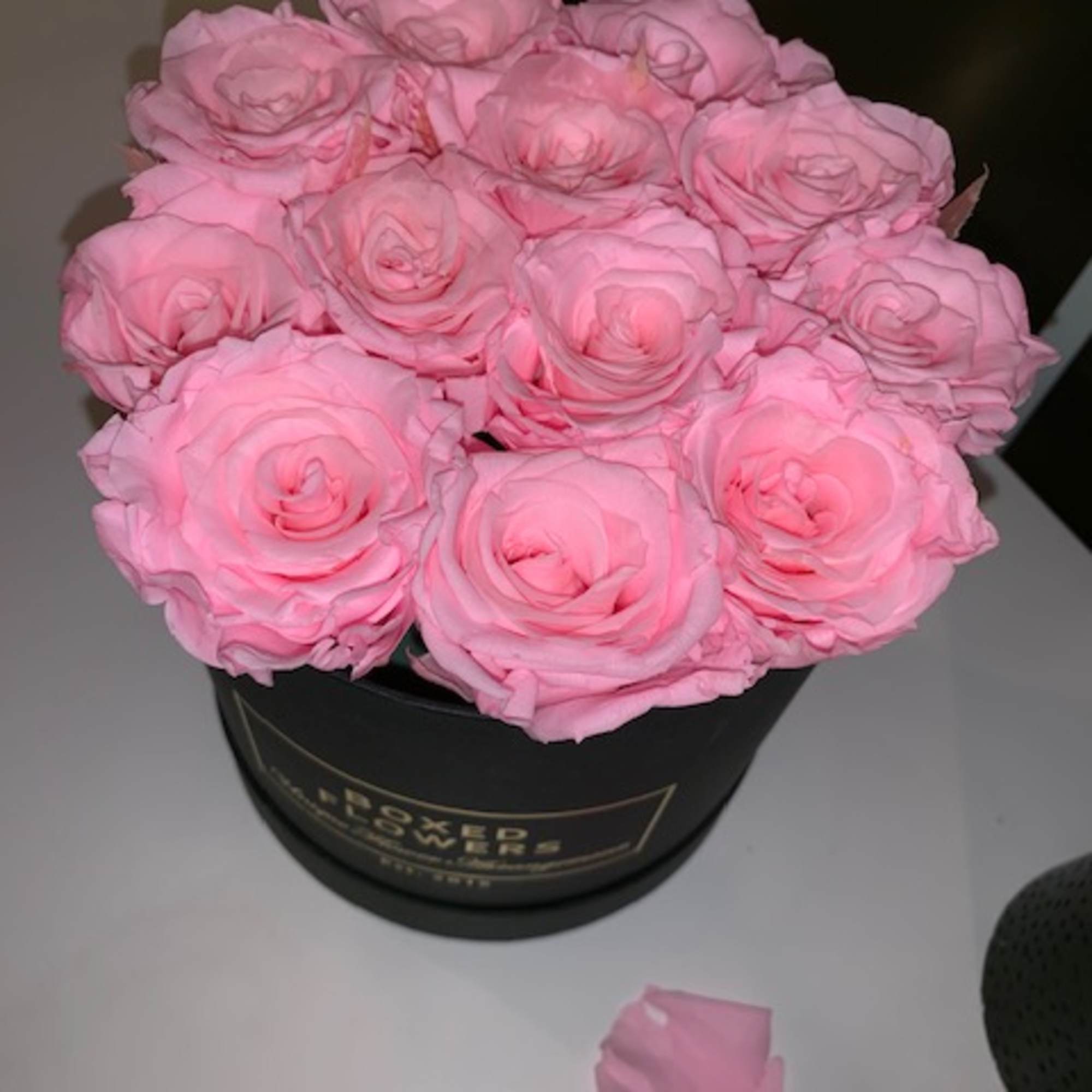 Bouquet of pink roses in a black round box