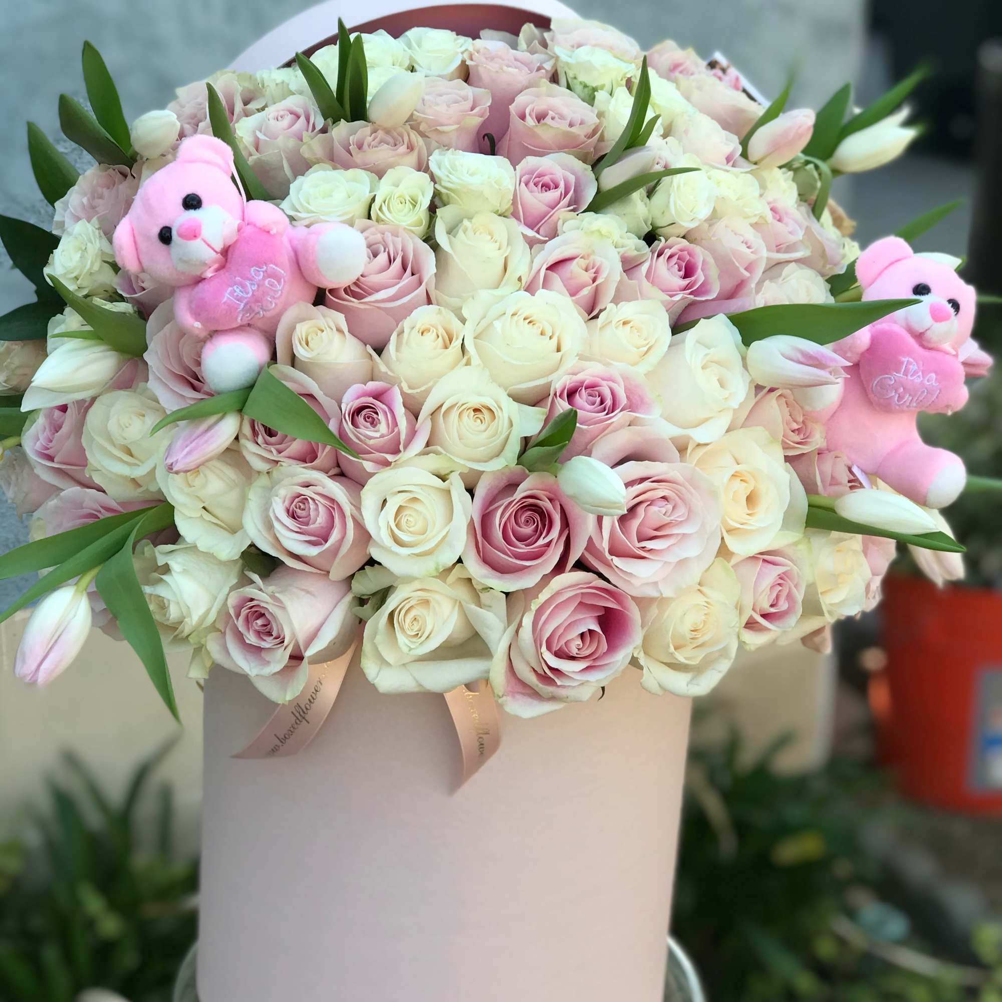 Pink and white rose bouquet in a round box with two small teddy bears