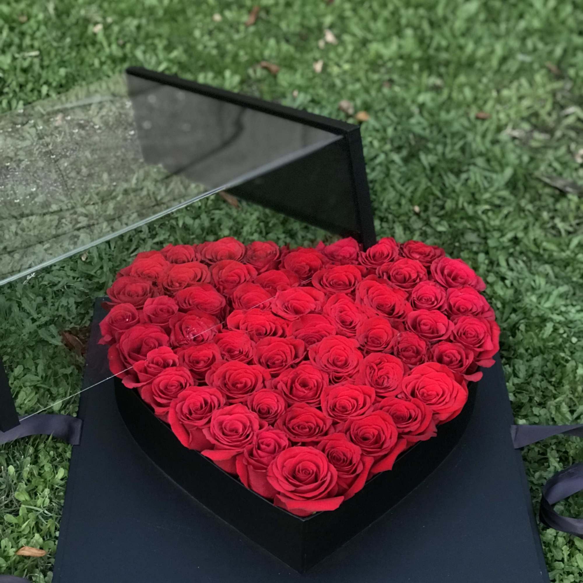Heart-shaped box filled with red roses