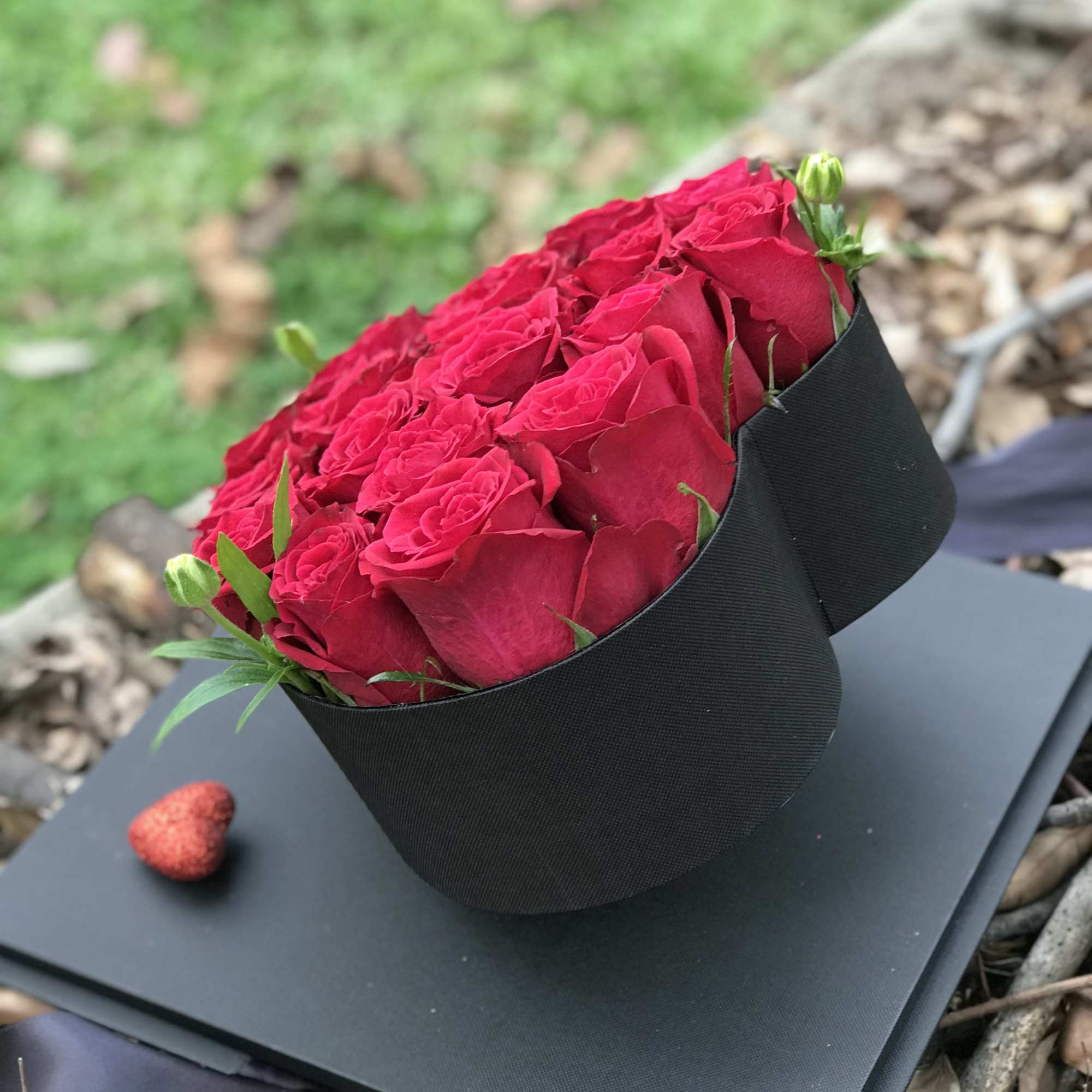 Bouquet of red roses wrapped in black paper