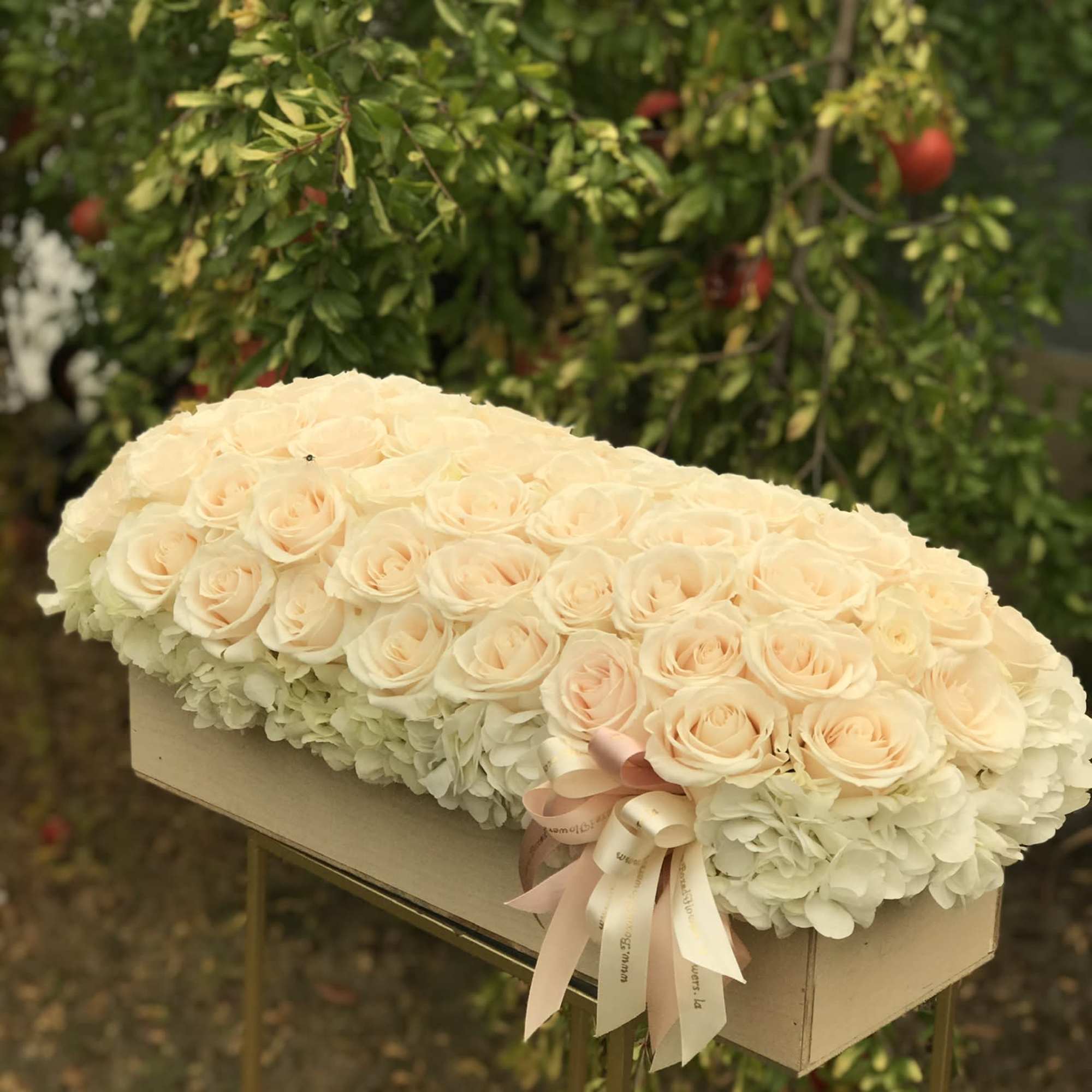 Cream rose and hydrangea arrangement in a rectangular box with ribbon