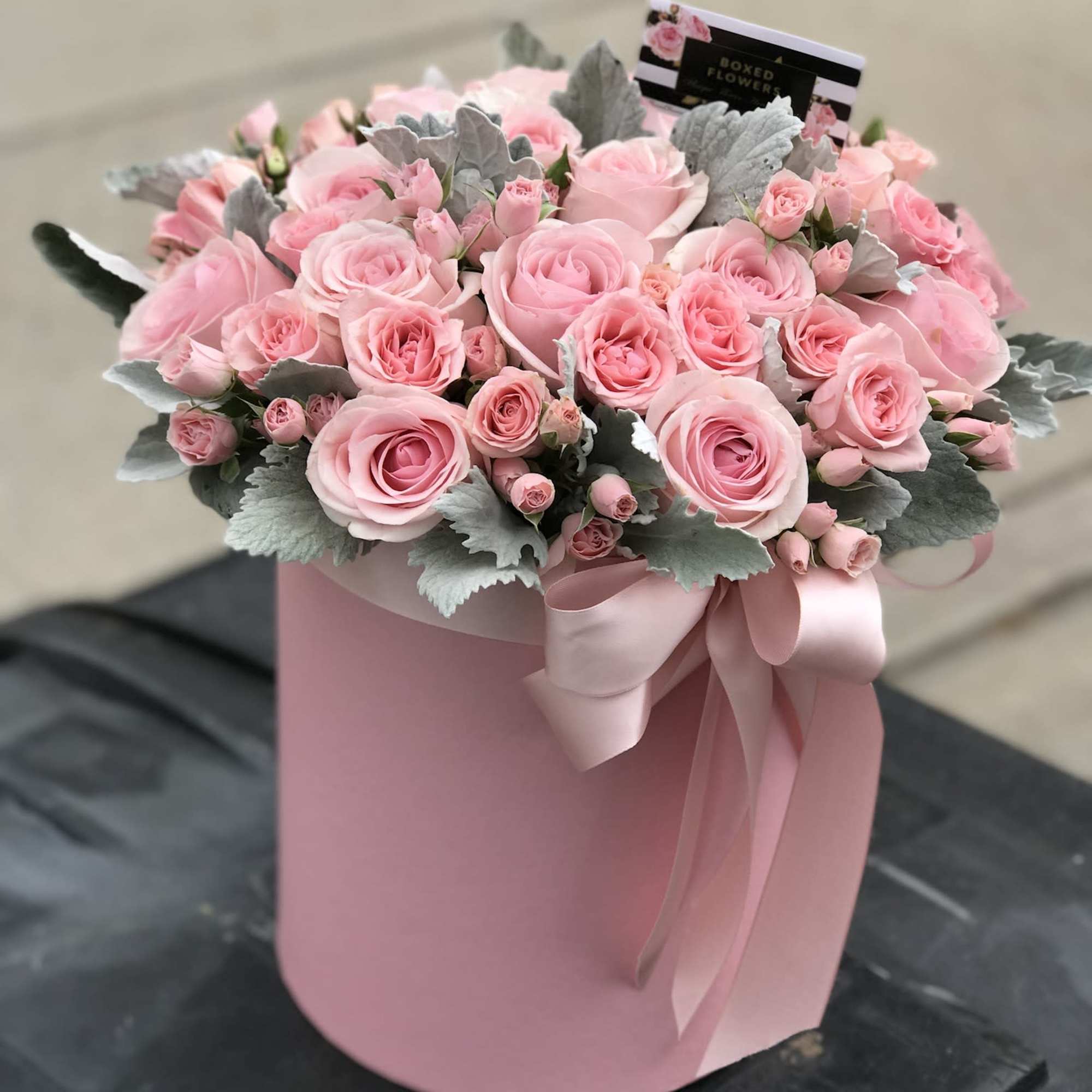 Pink roses arranged in a round pink box with a ribbon, photo 3 of 3