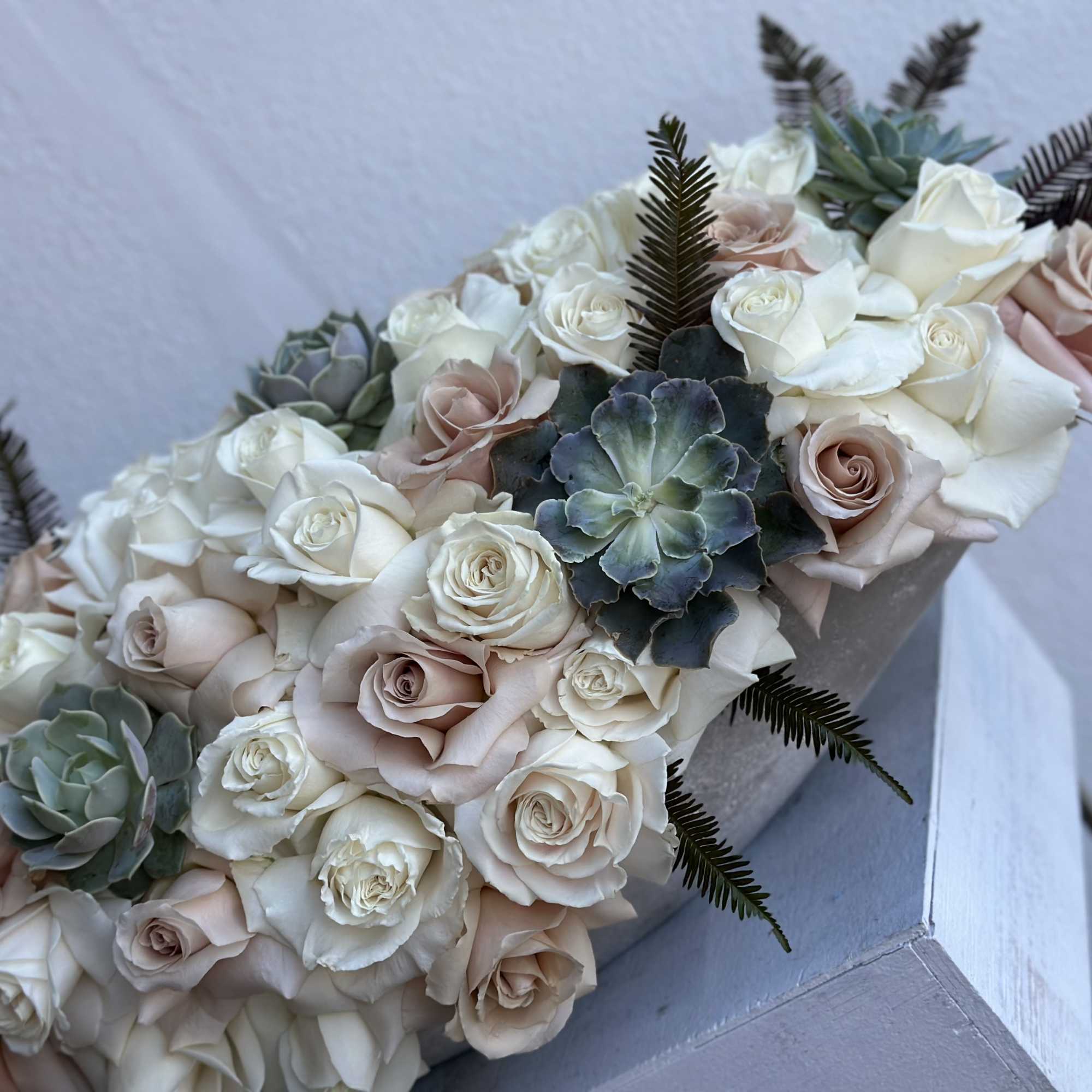 Bouquet of blush and white roses with succulents