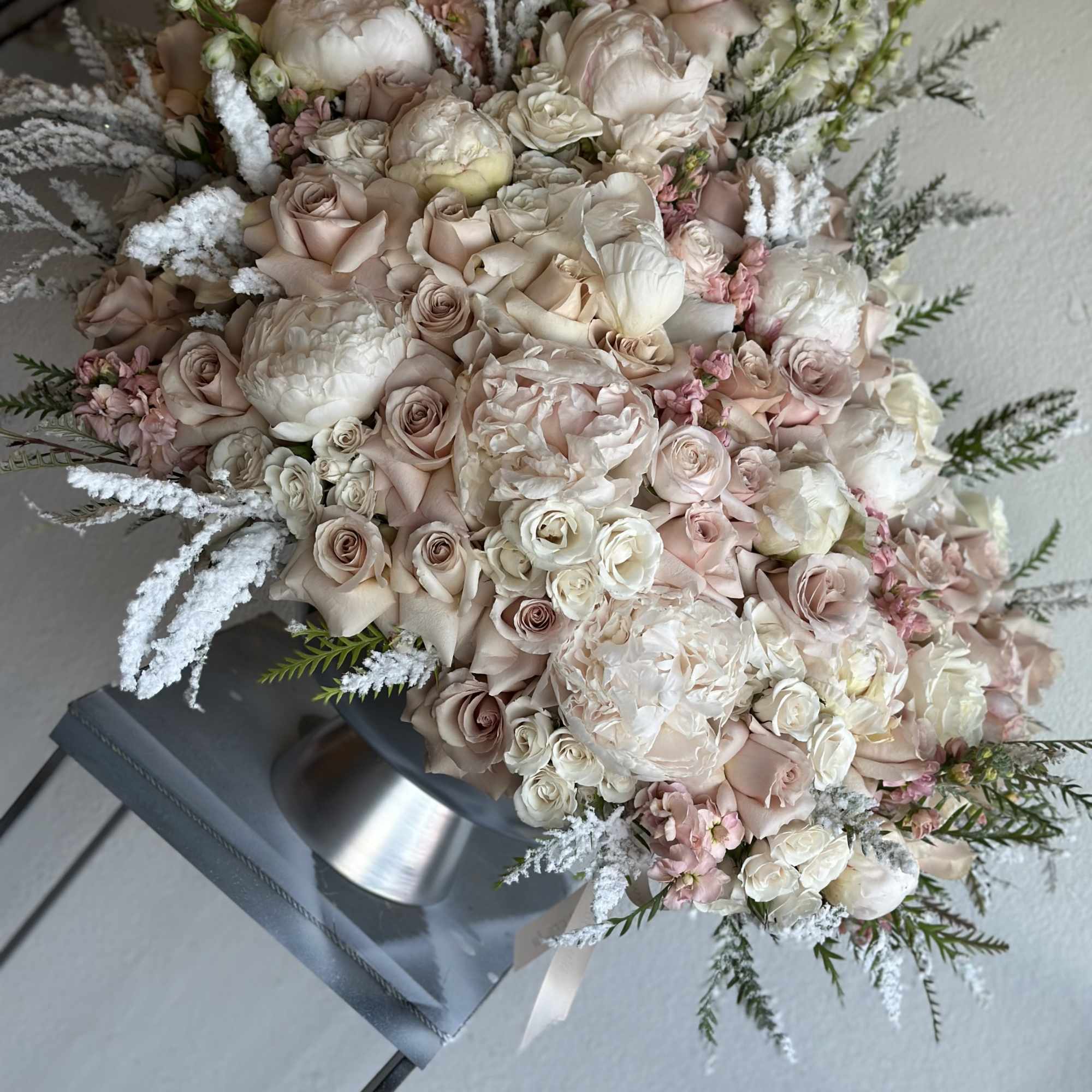 Large bouquet of blush and white roses with pale filler flowers