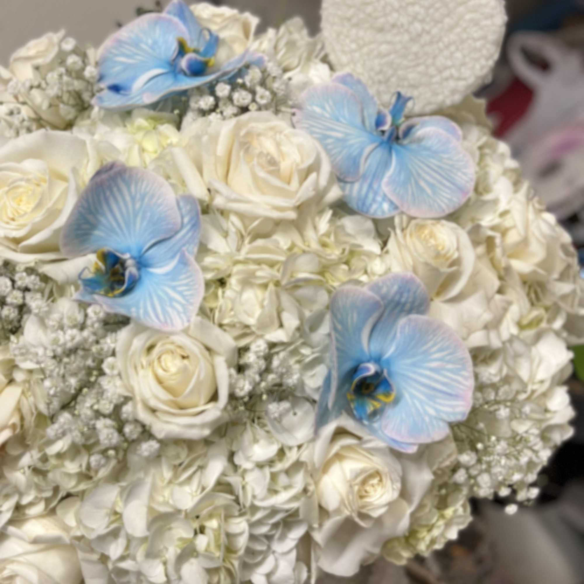 White rose and hydrangea bouquet with blue orchids