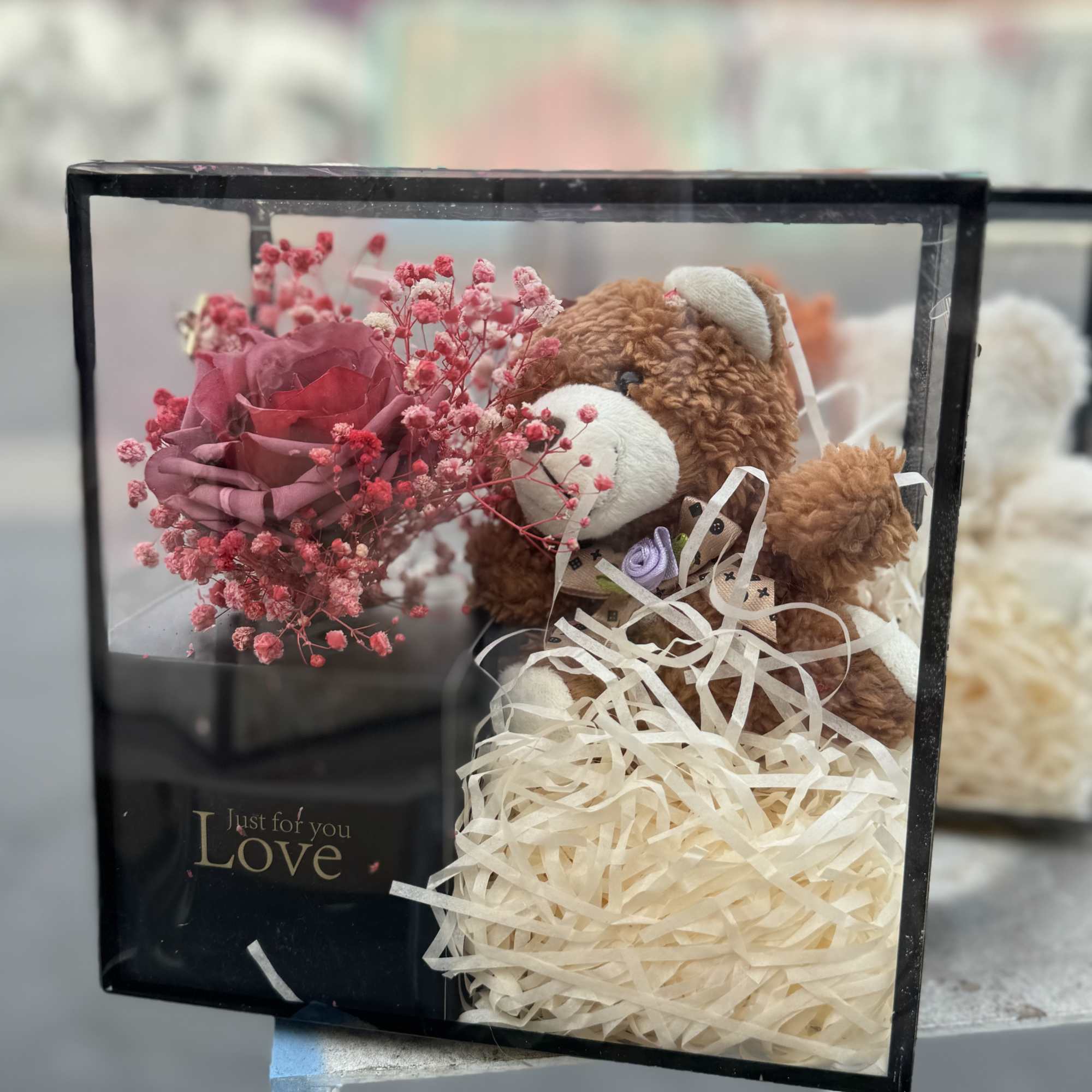 Teddy bear in a gift box with a pink rose and baby’s breath