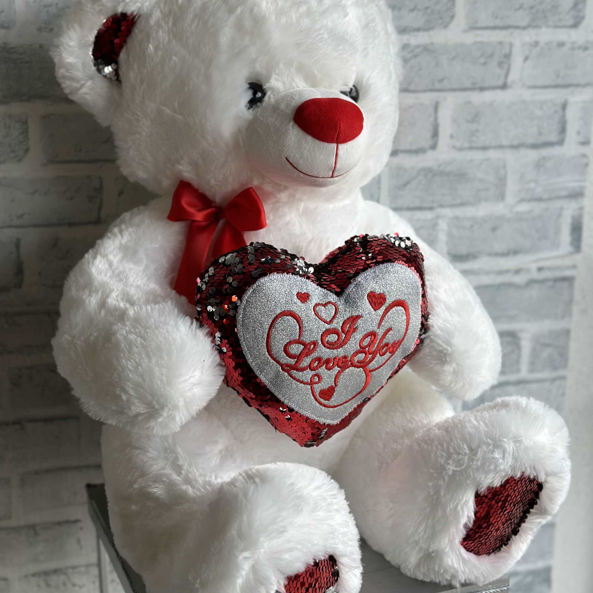 White teddy bear holding a red heart with "I Love You" text
