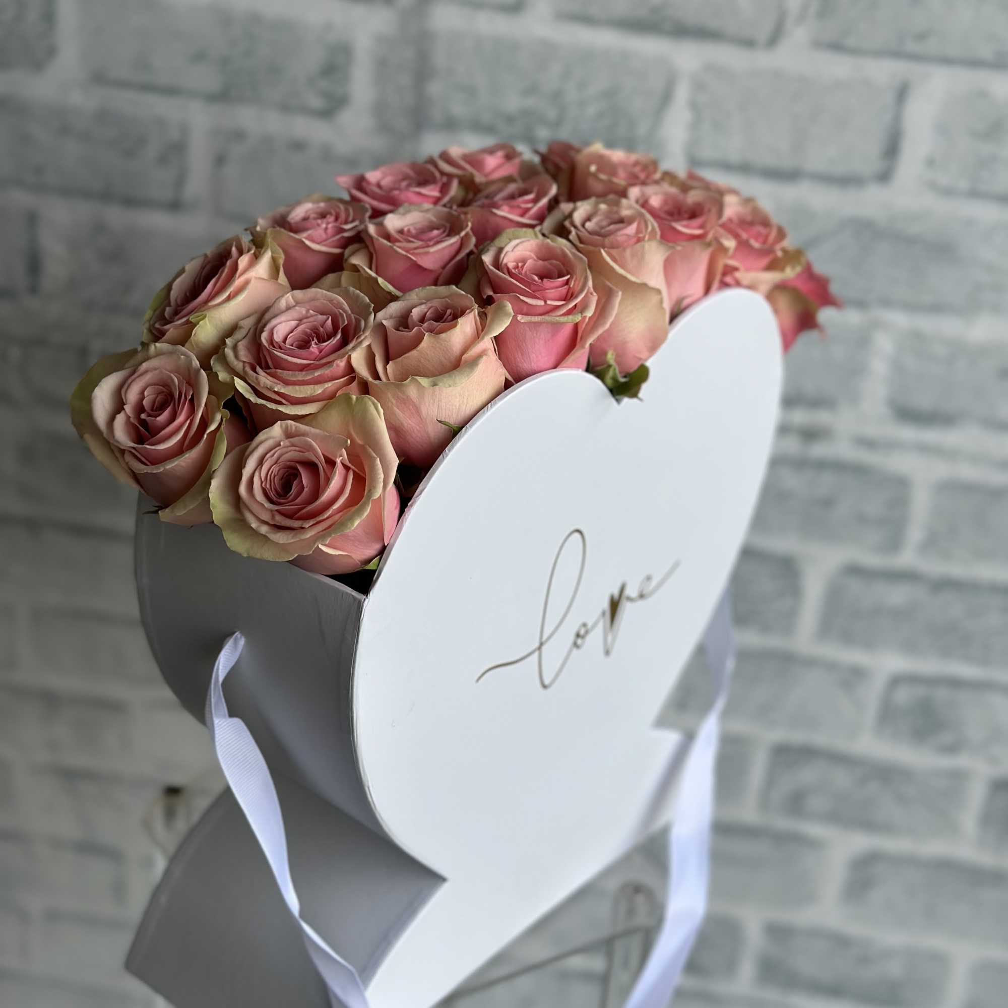 White heart shaped bag box filled with 20 luscious pink roses.