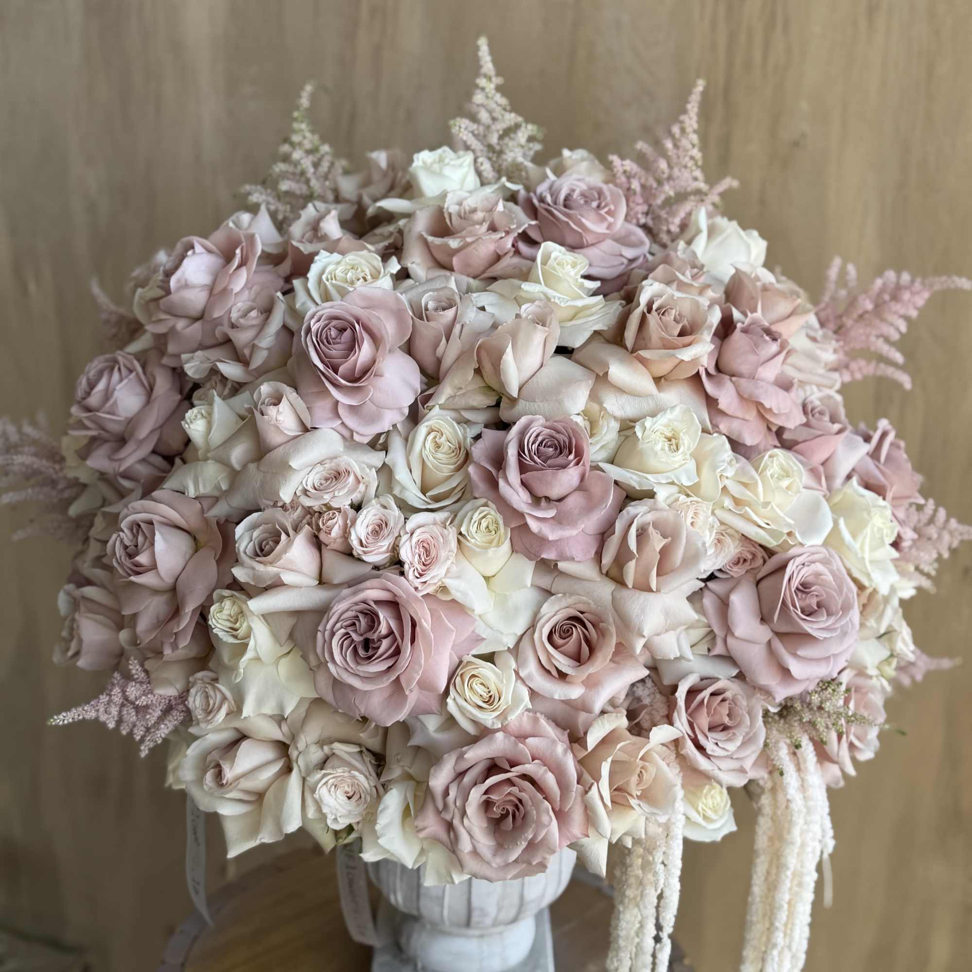 Large bouquet of blush and ivory roses in a vase