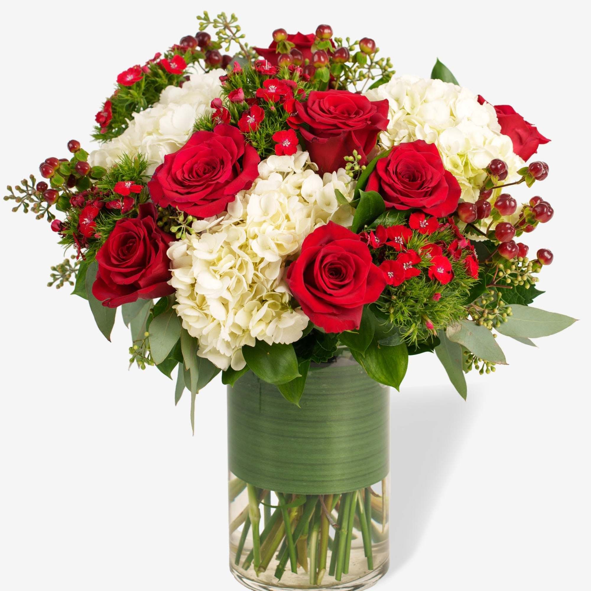 Red roses and white hydrangeas in a glass vase
