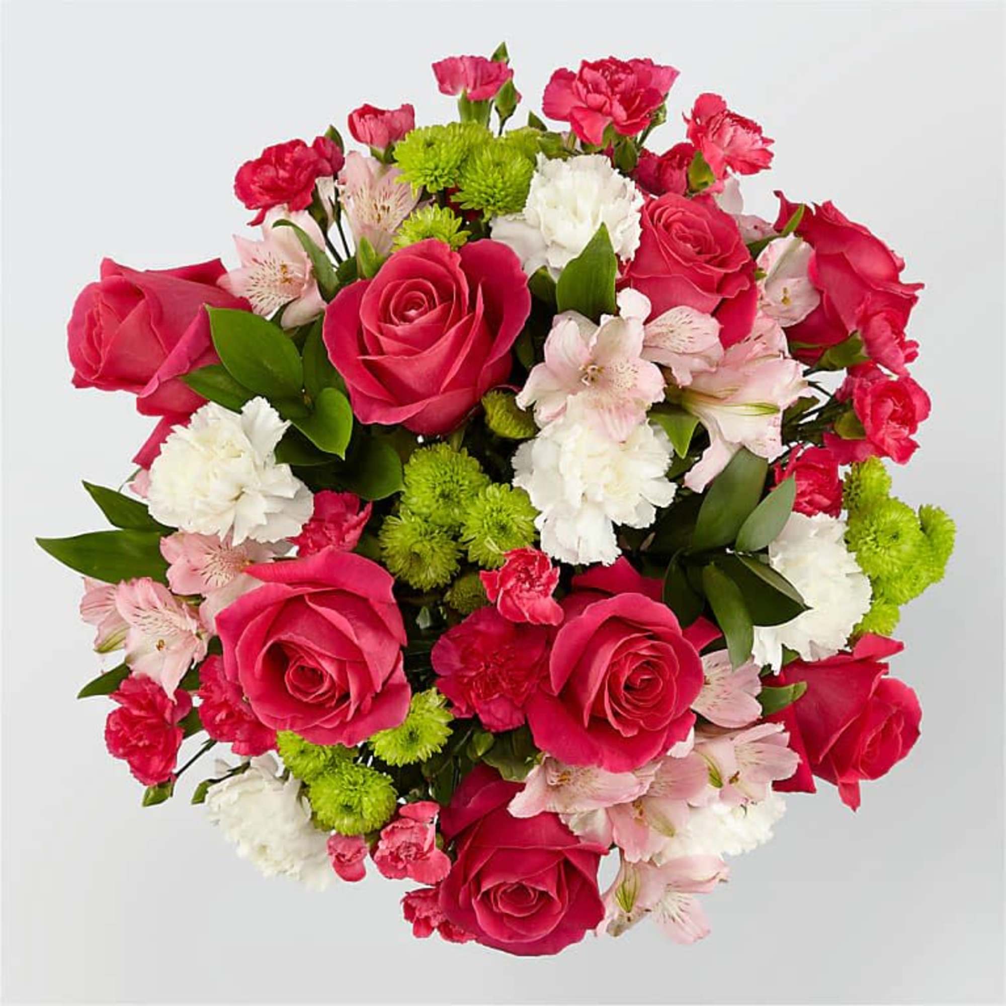Round bouquet of pink roses, carnations, and white blooms with green accents