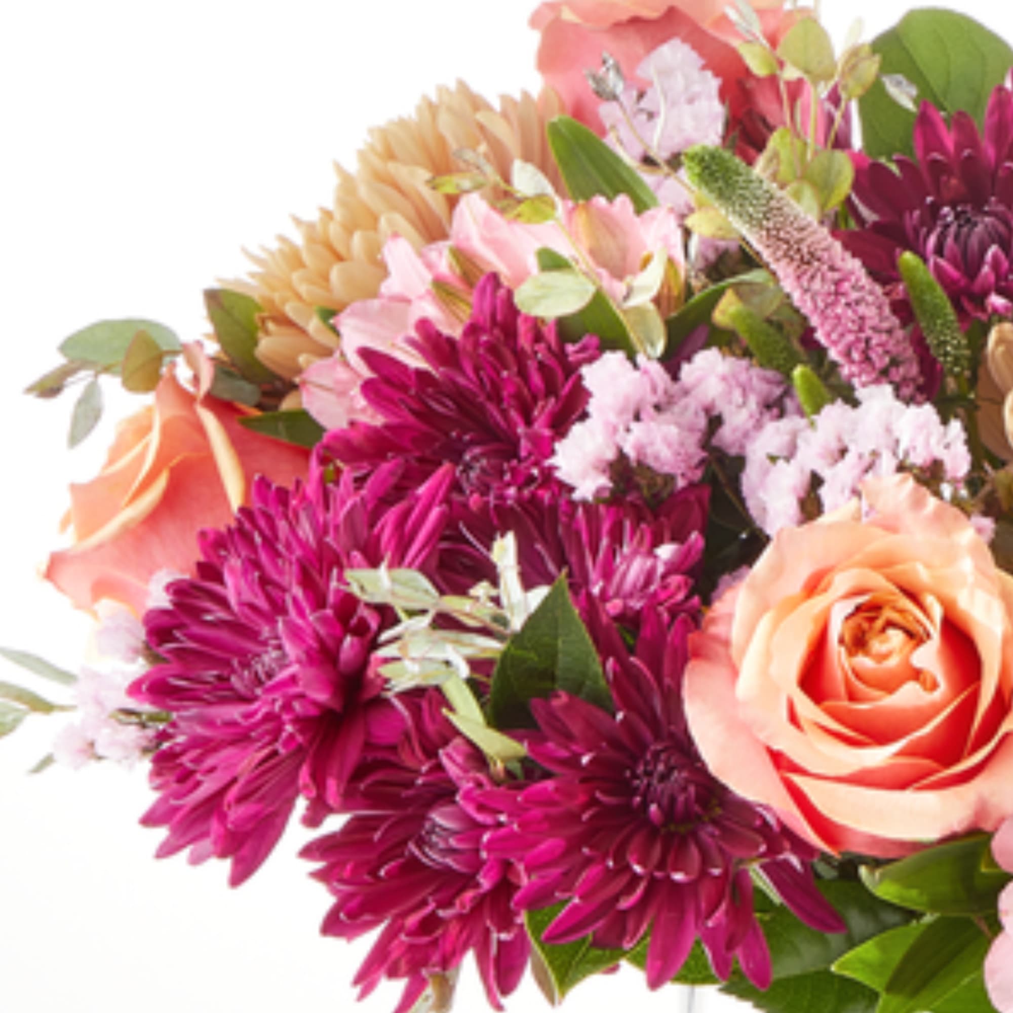 Bouquet of pink and peach flowers with purple blooms