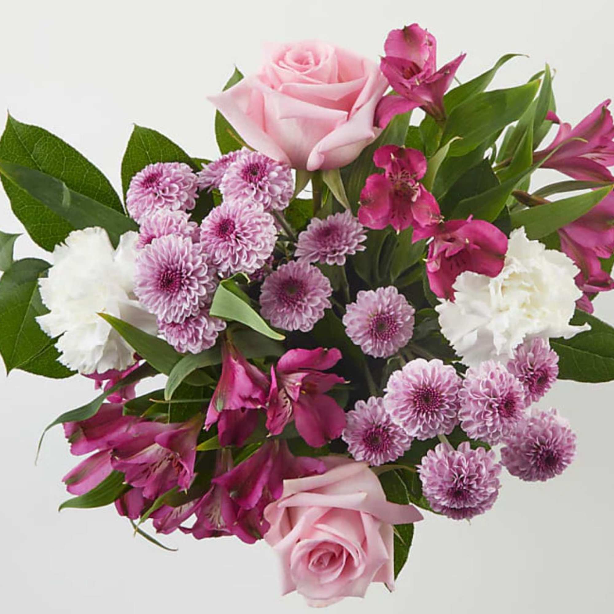 Pink roses with purple mums and white carnations in a bouquet