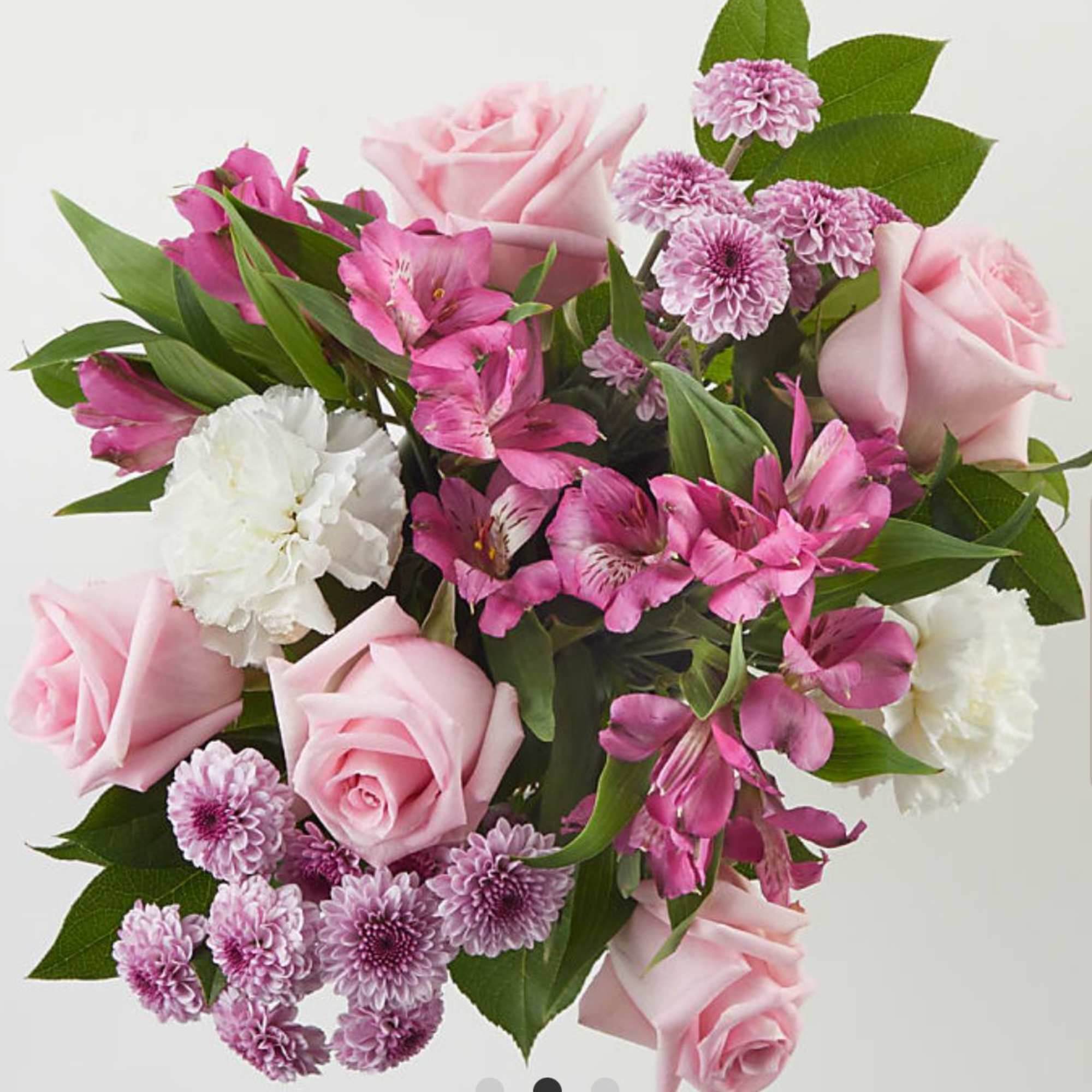 Pink roses and purple flowers arranged in a bouquet