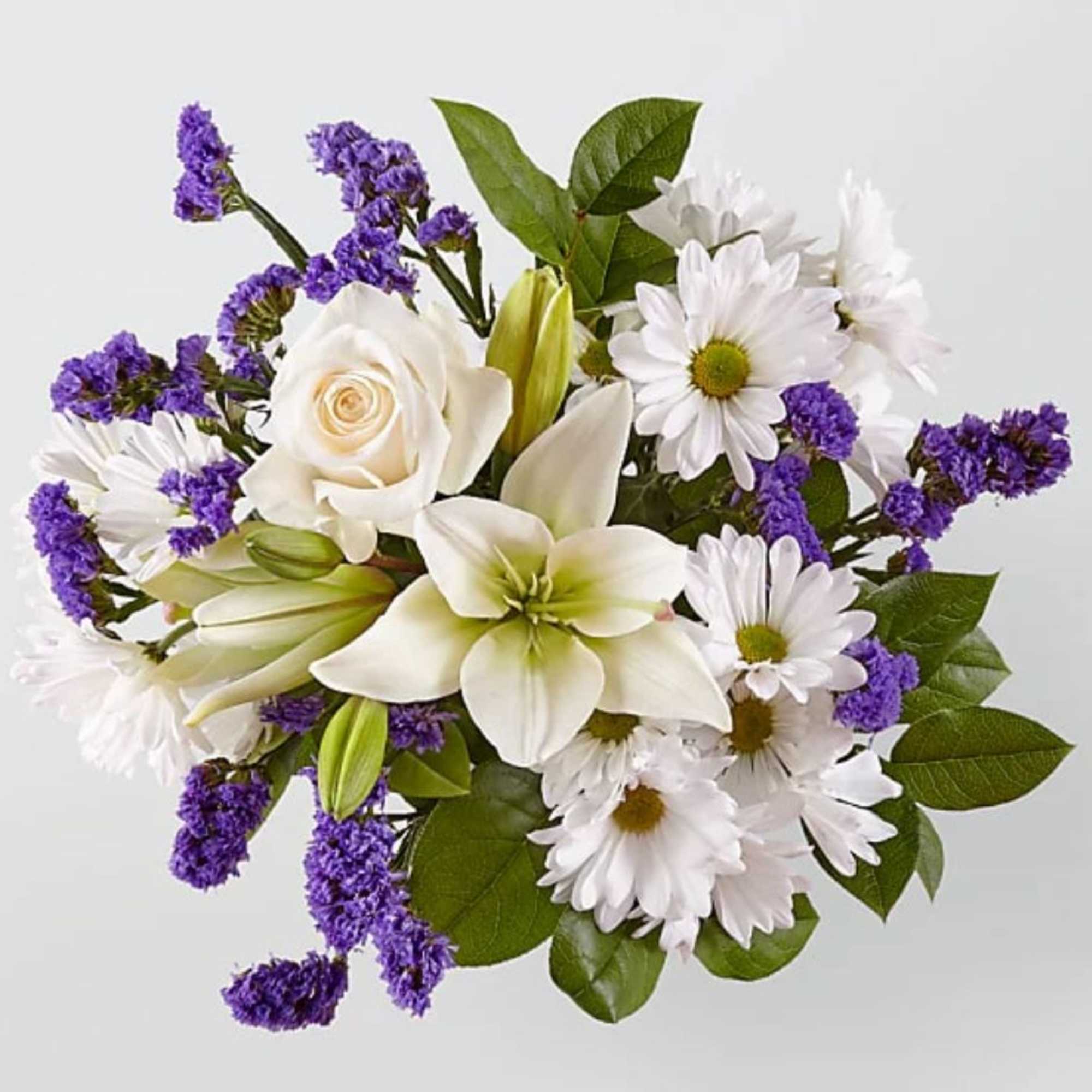 White lilies, roses, and daisies with purple filler flowers