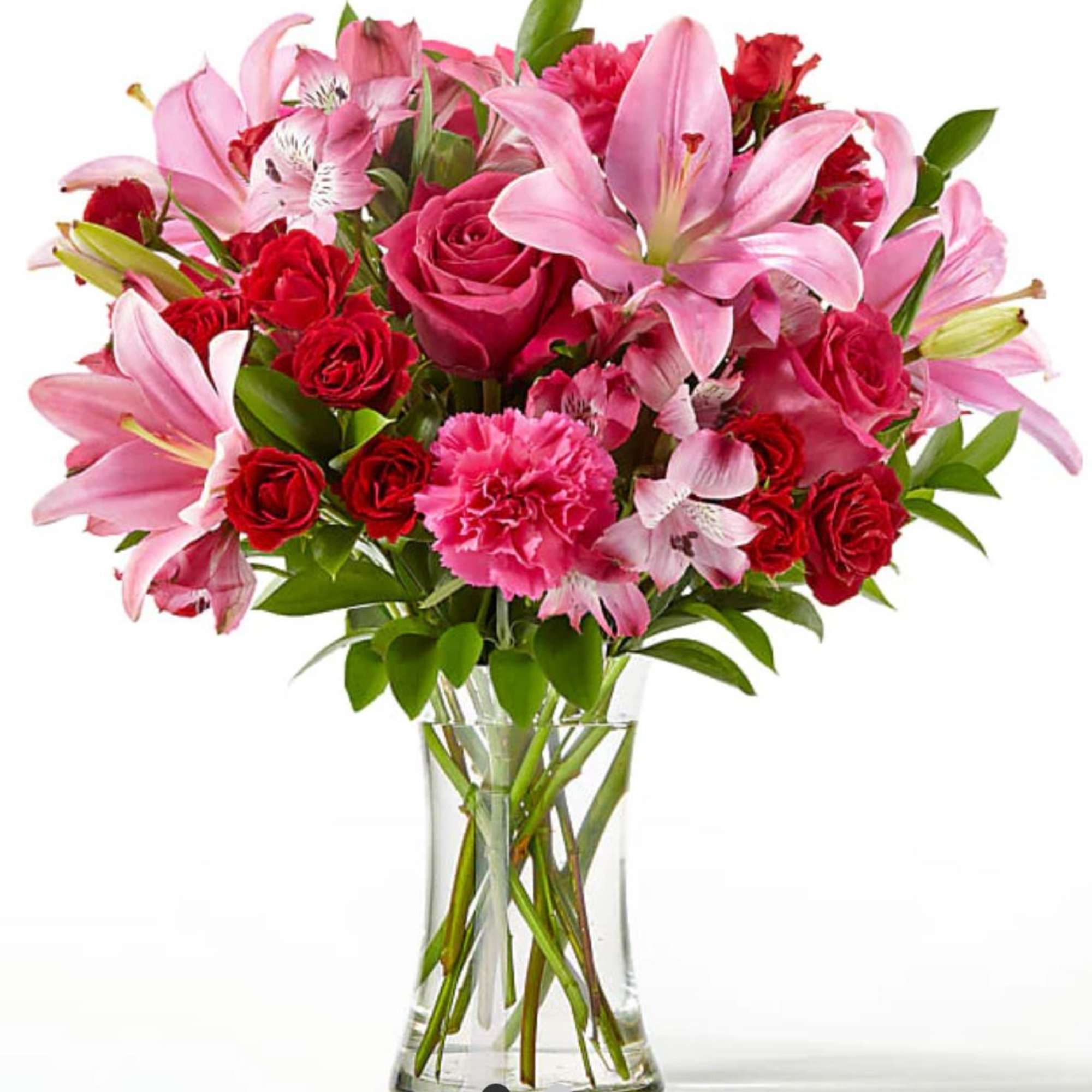 Pink lilies and red roses in a clear glass vase