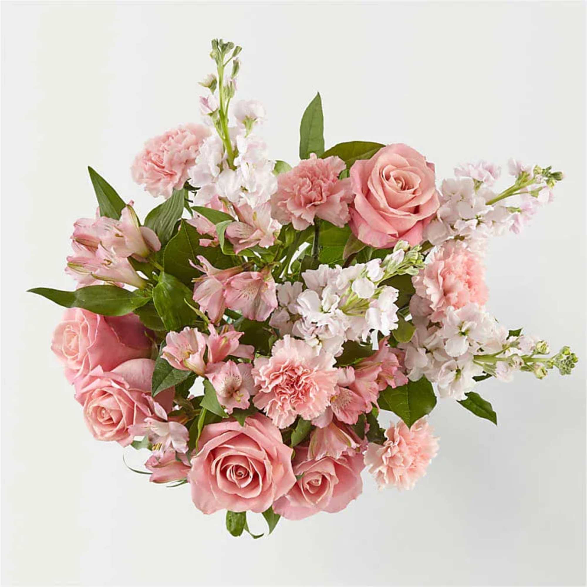 Pink roses and carnations with white filler flowers in a bouquet