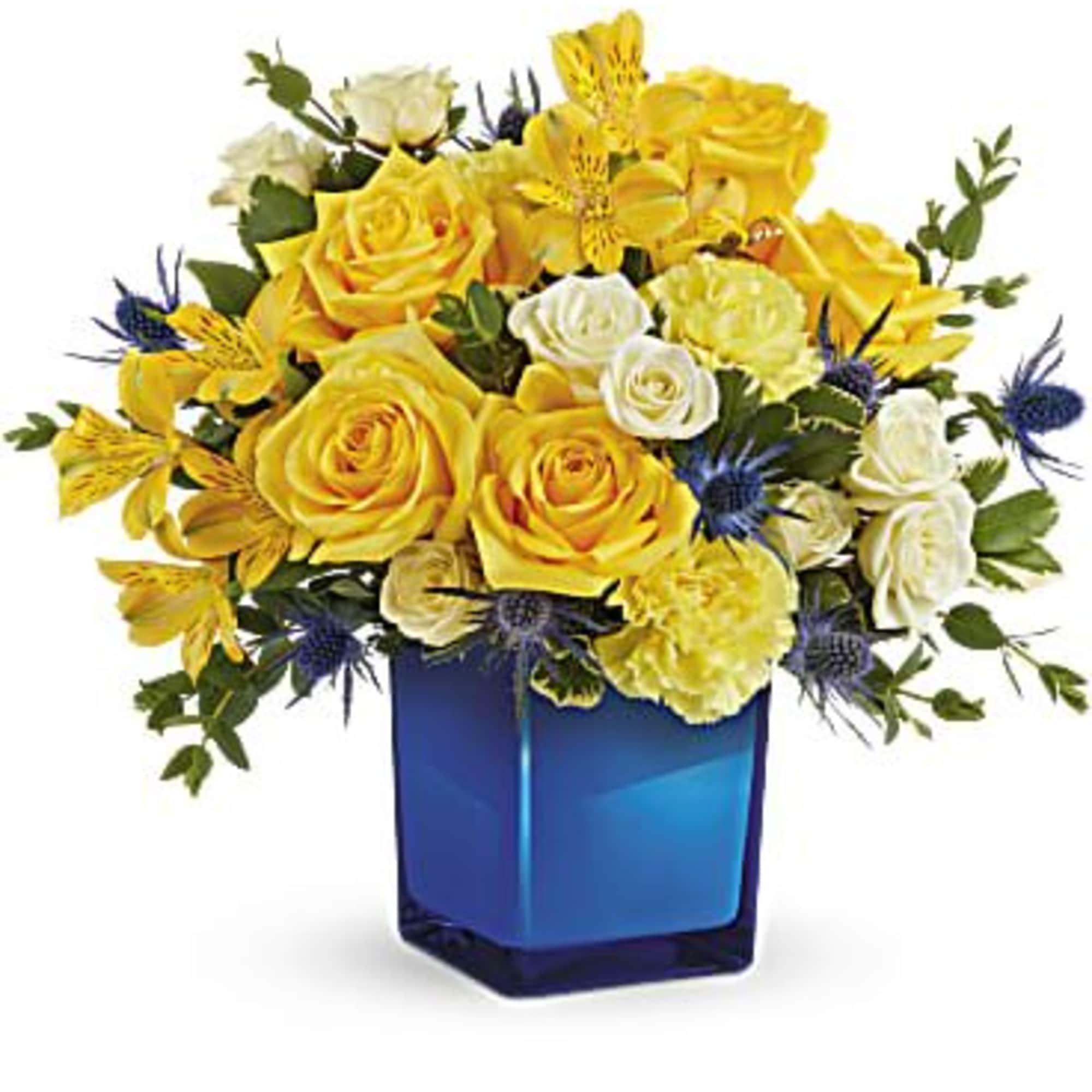 Yellow and white rose bouquet in a blue glass vase