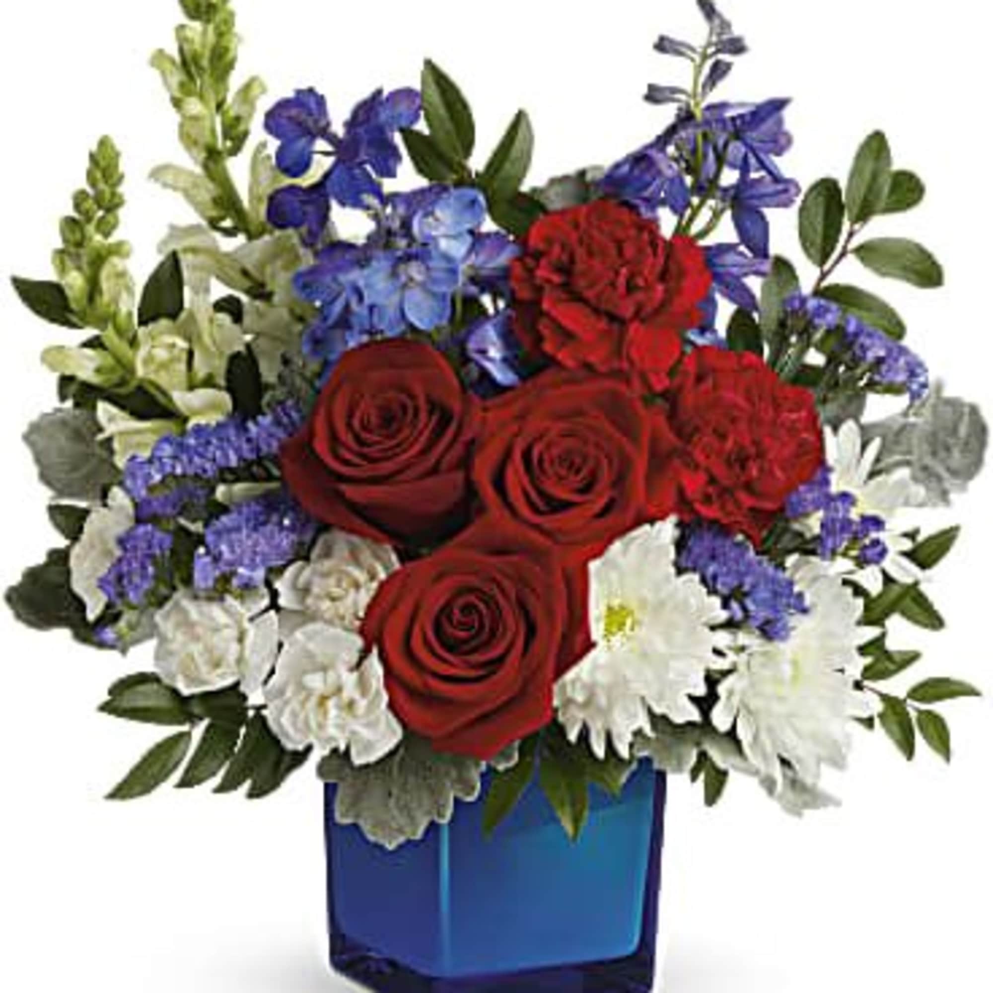Red roses and white flowers in a blue glass vase
