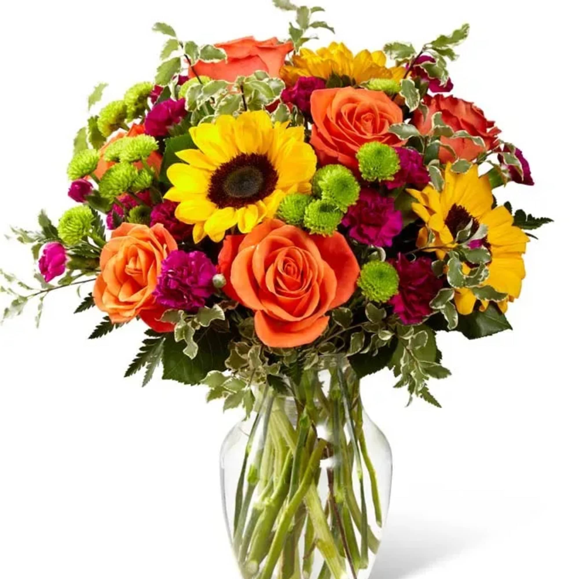 Bouquet of orange roses and yellow sunflowers in a clear glass vase