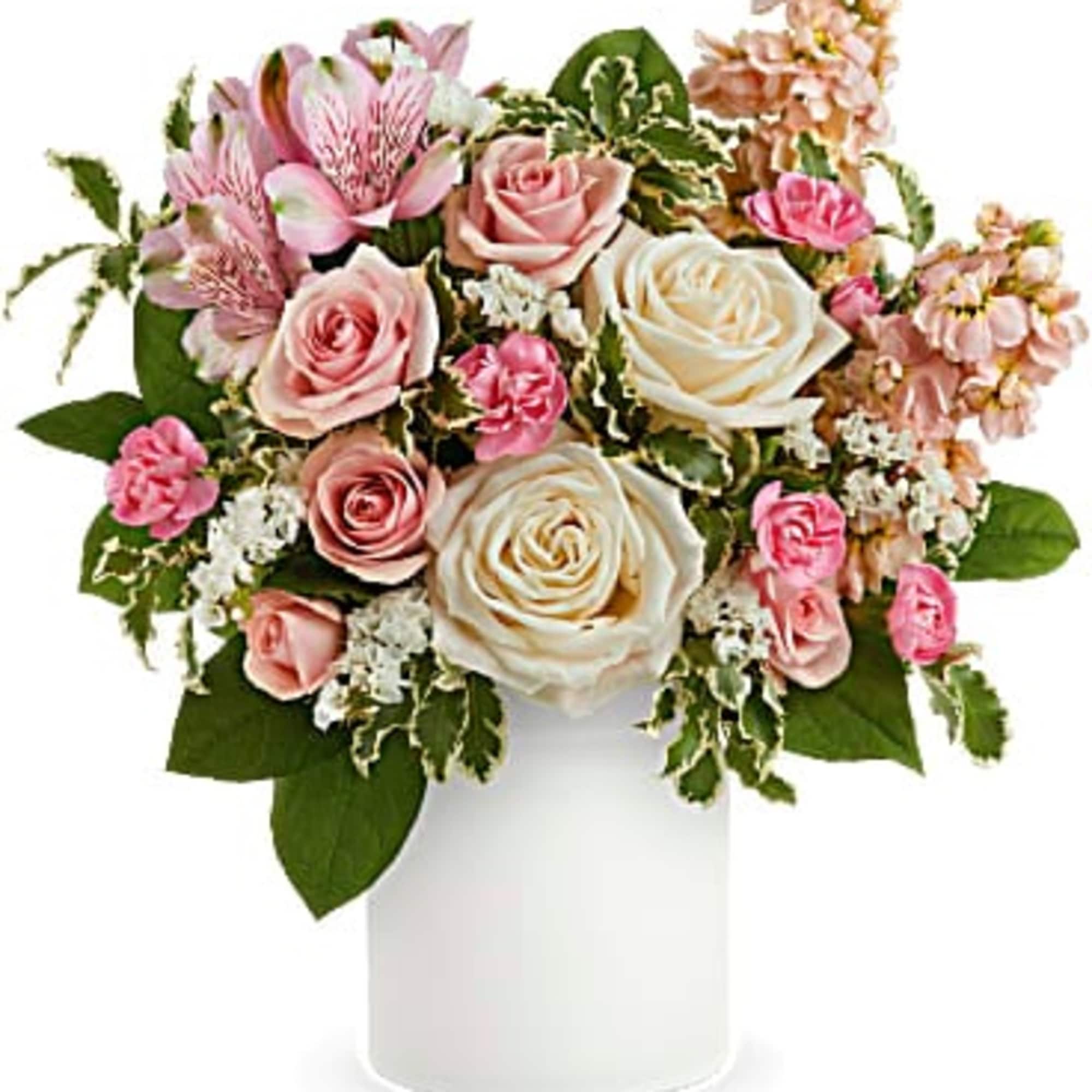 Pink and white rose bouquet in a white vase