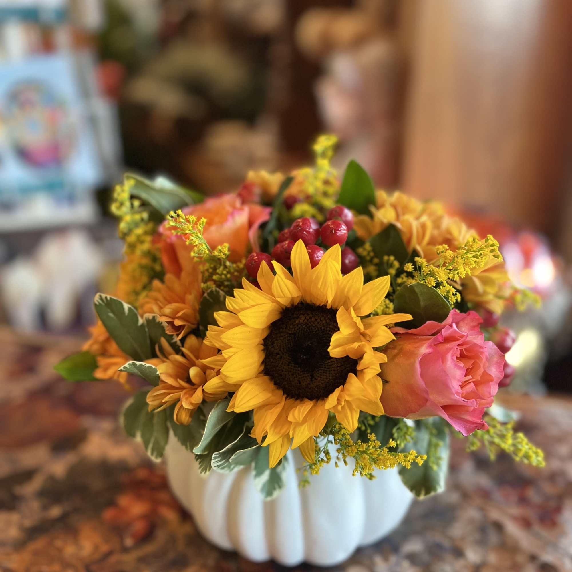 Sunflowers, orange roses, solid aster, red hypericum berries, daisy poms, thoughtfully arranged
