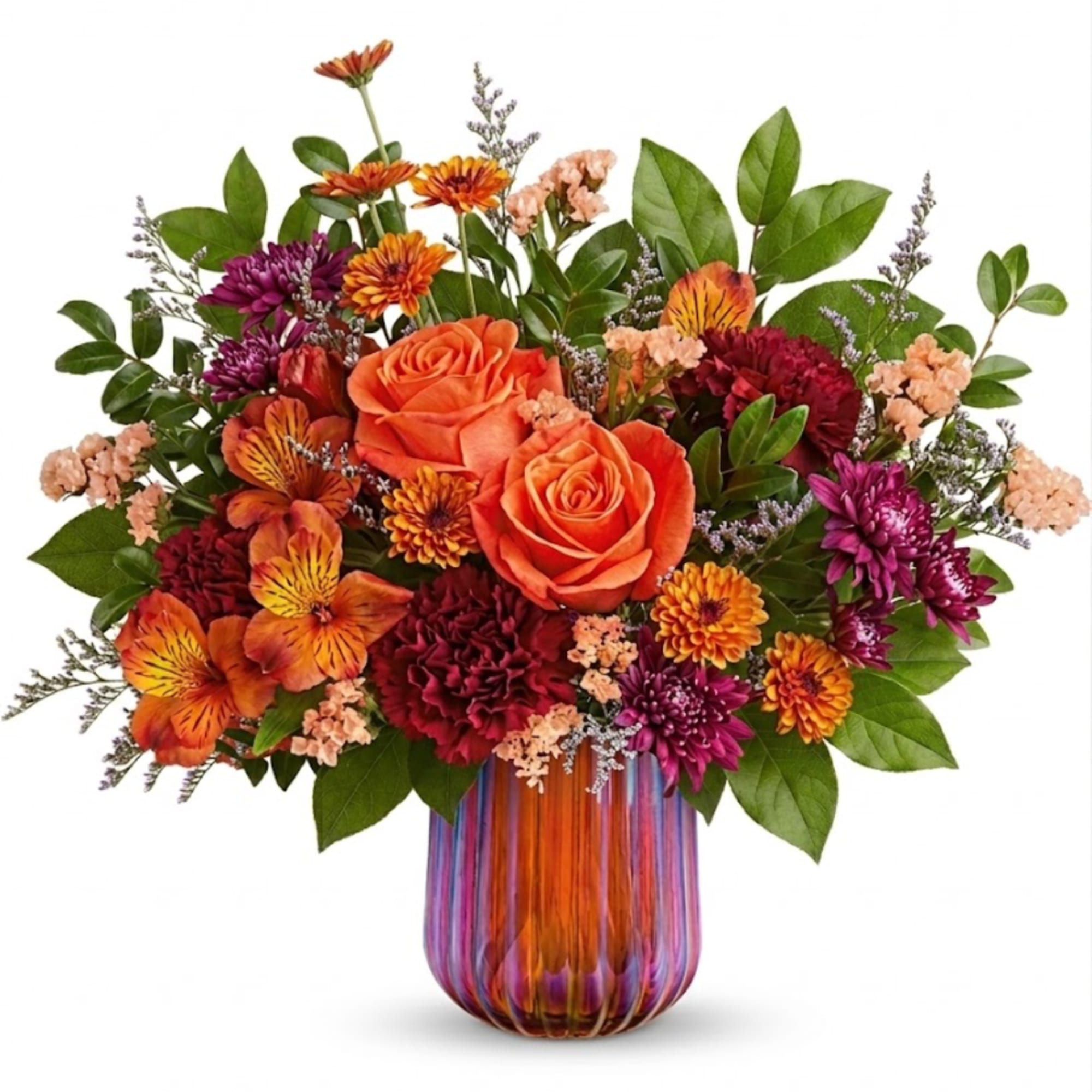 Orange and purple mixed bouquet in a striped glass vase