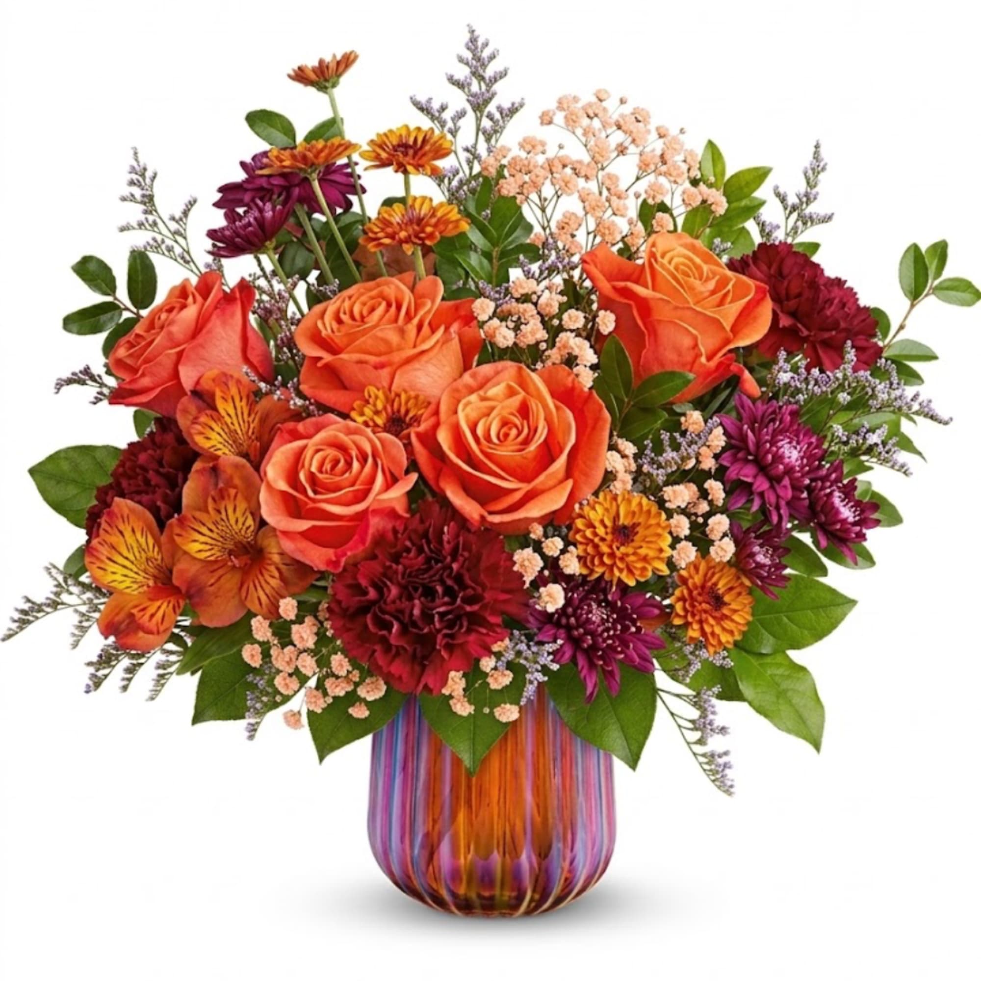 Orange roses and mixed chrysanthemums in a striped glass vase