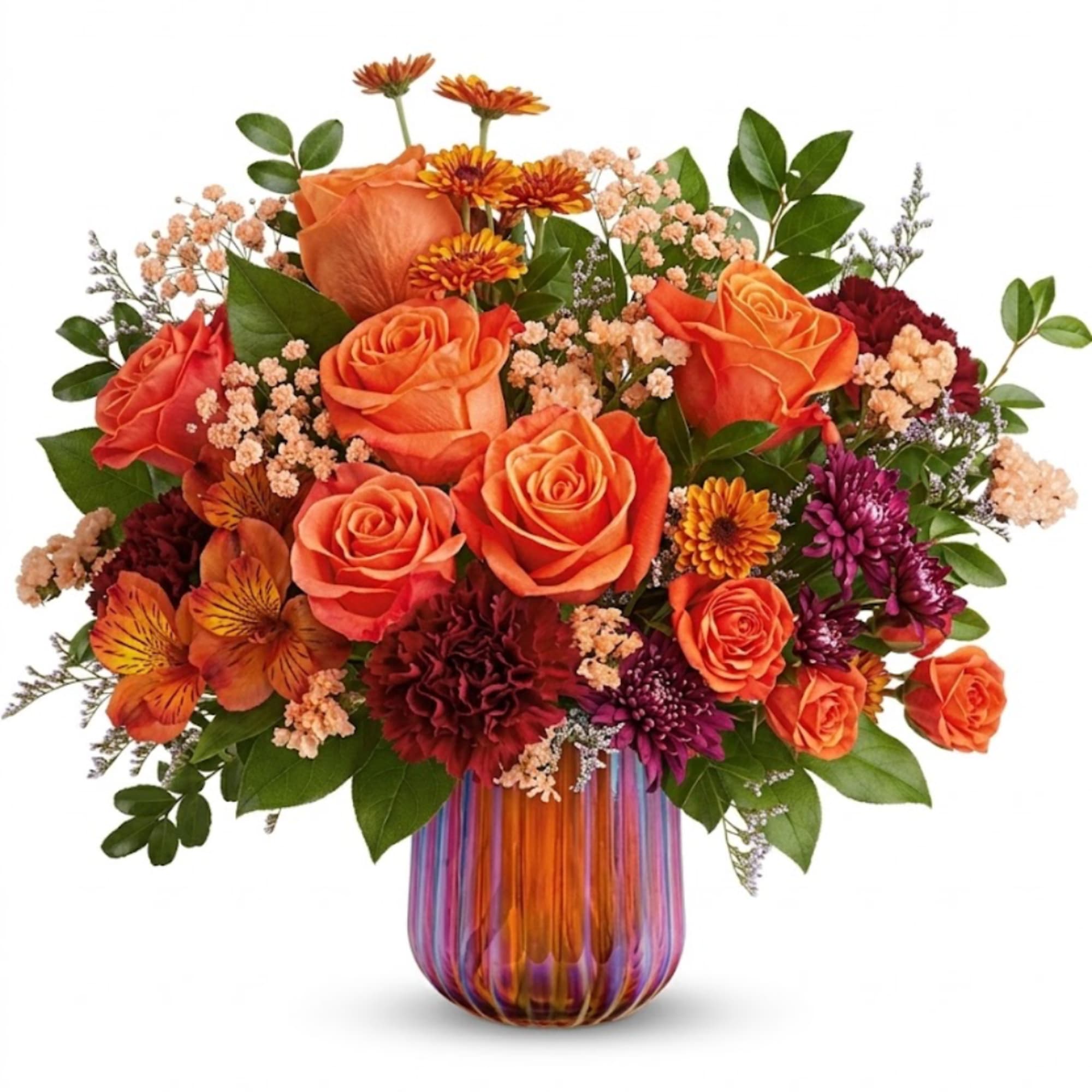 Orange roses and mixed flowers in a striped glass vase