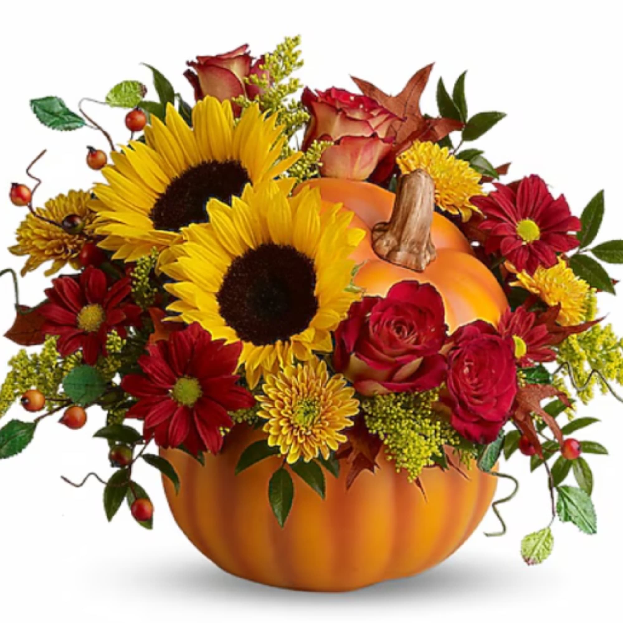Fall floral arrangement in a pumpkin container with sunflowers and red roses
