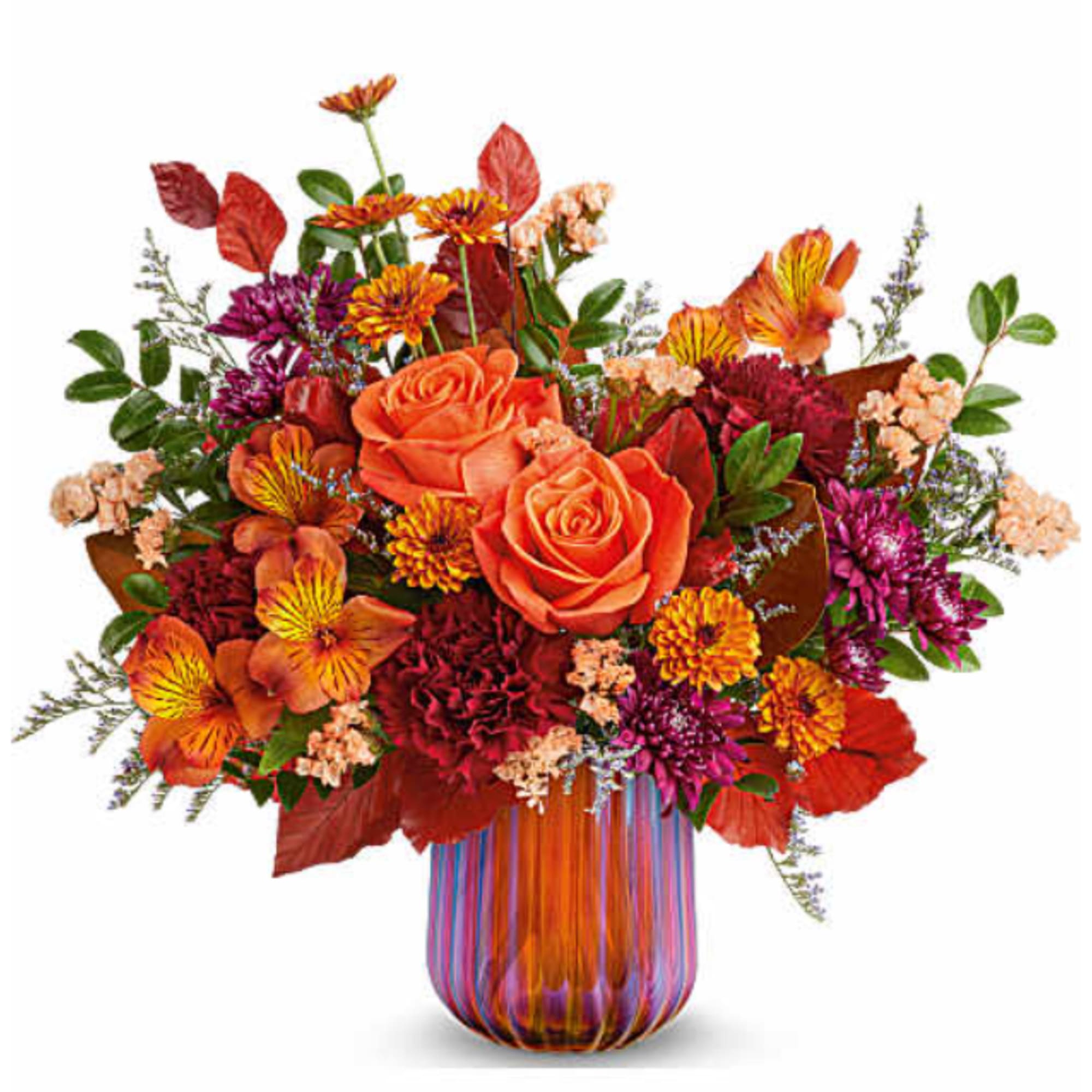 Orange roses and mixed autumn flowers in a striped glass vase