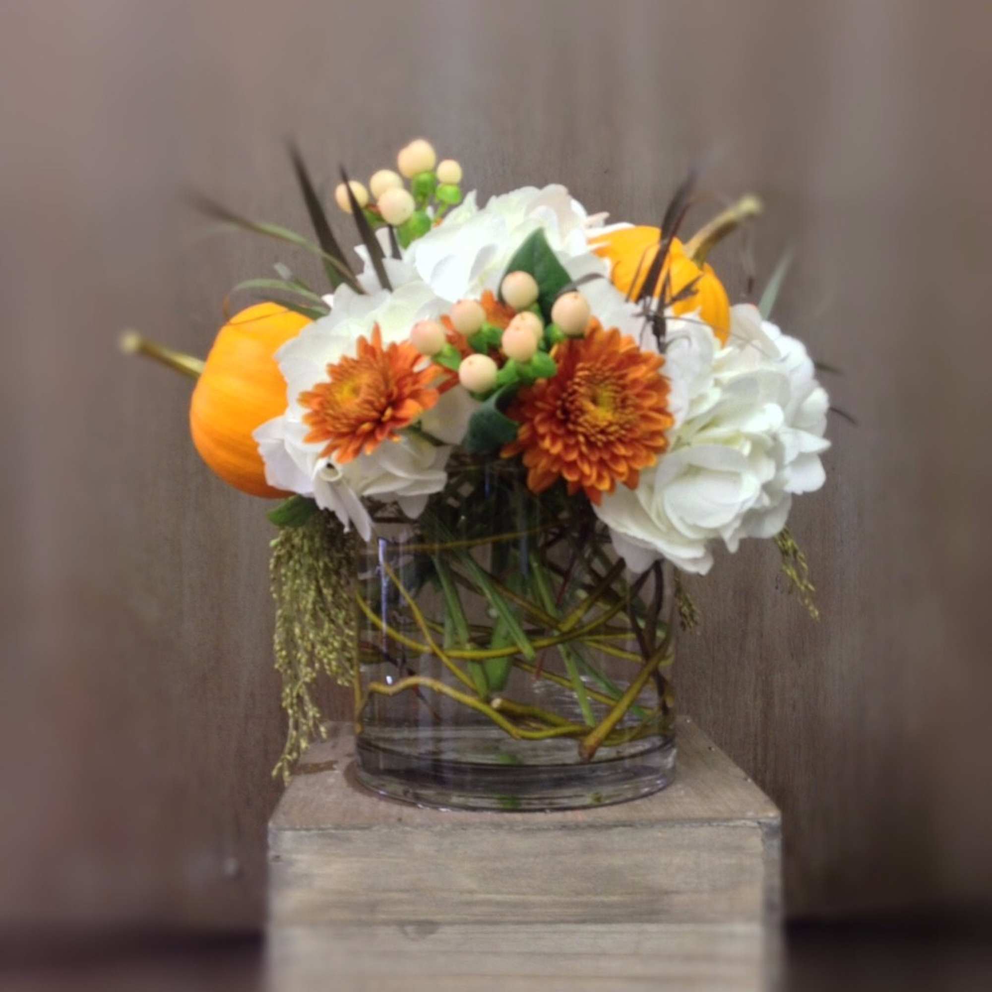 White hydrangea, fall mums, hypericum berries and mini pumpkins nestled in a, photo 2 of 2