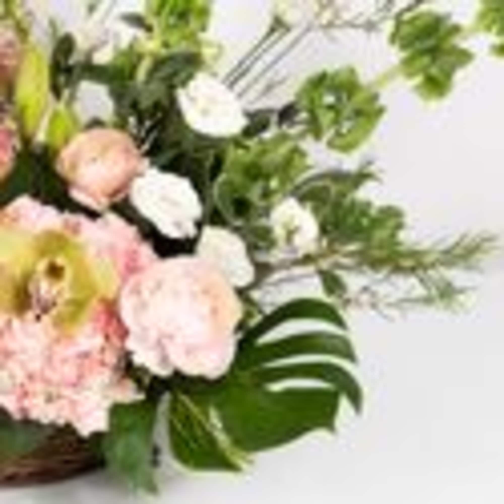 Pink and white flowers arranged in a basket with green foliage