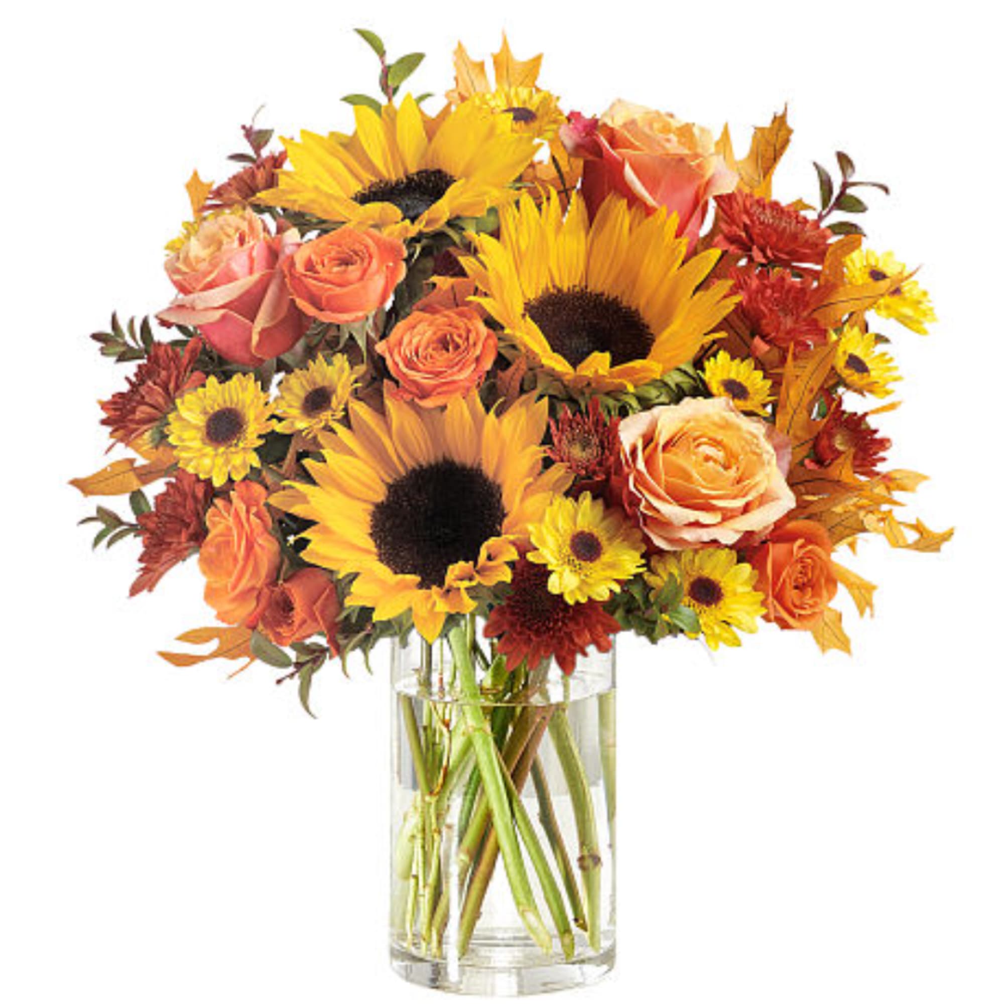 Bouquet of sunflowers, roses, and mums in a clear glass vase
