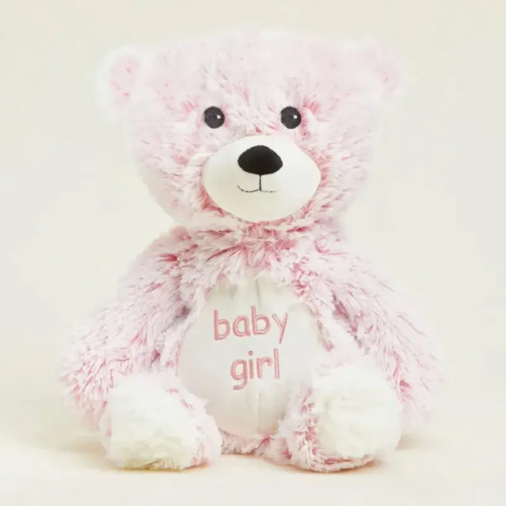 Pink and white teddy bear with "baby girl" text on its belly