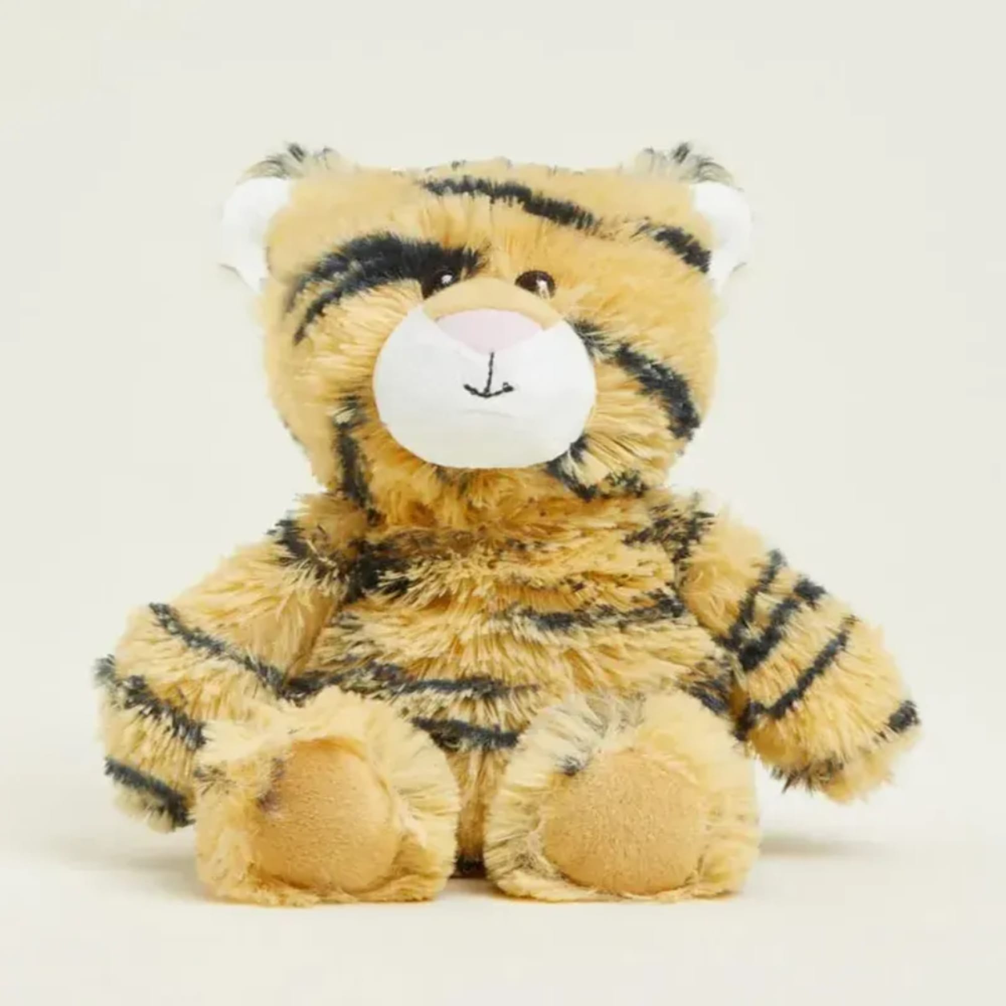 Plush tiger teddy bear sitting on a plain background