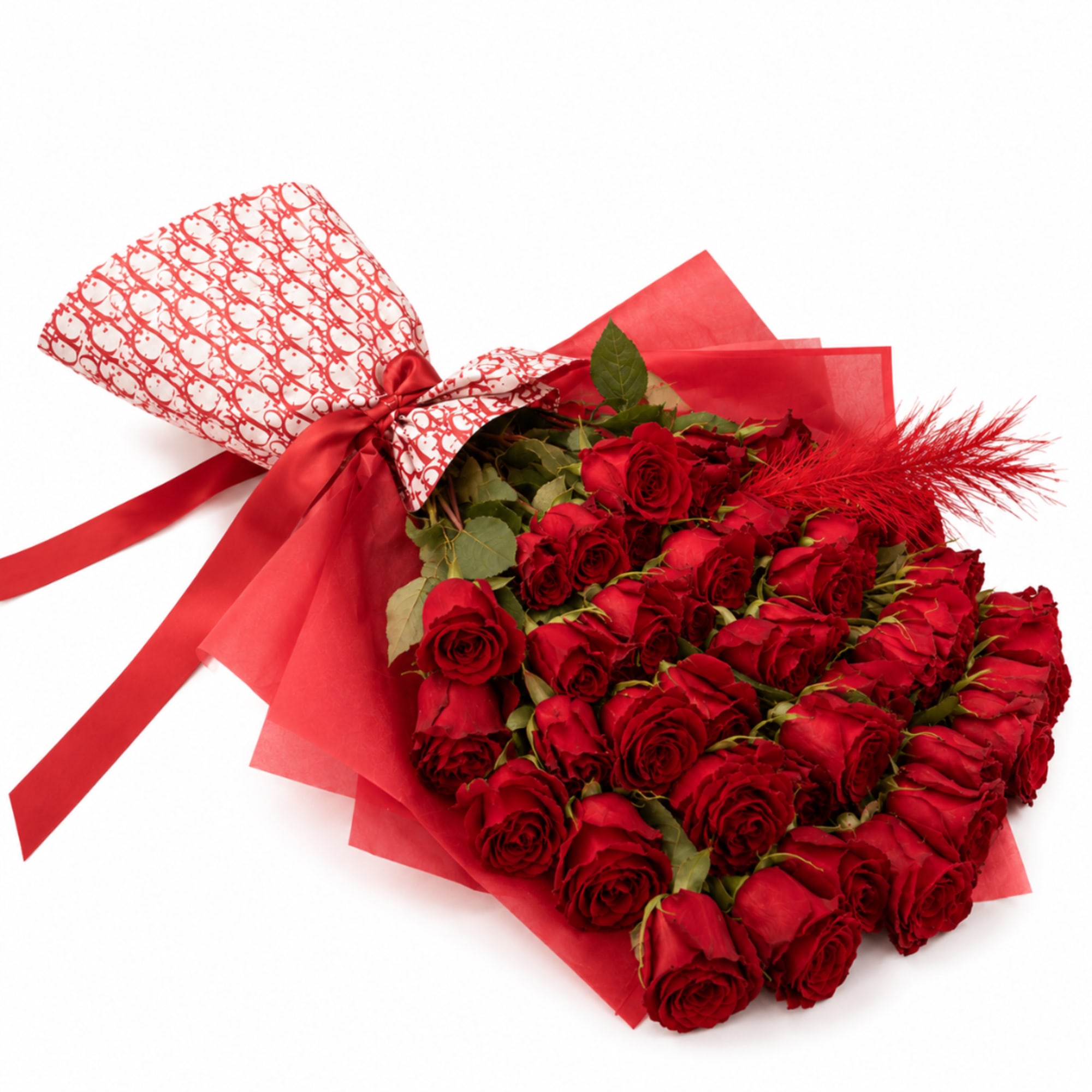 Bouquet of red roses wrapped in red paper with a satin ribbon