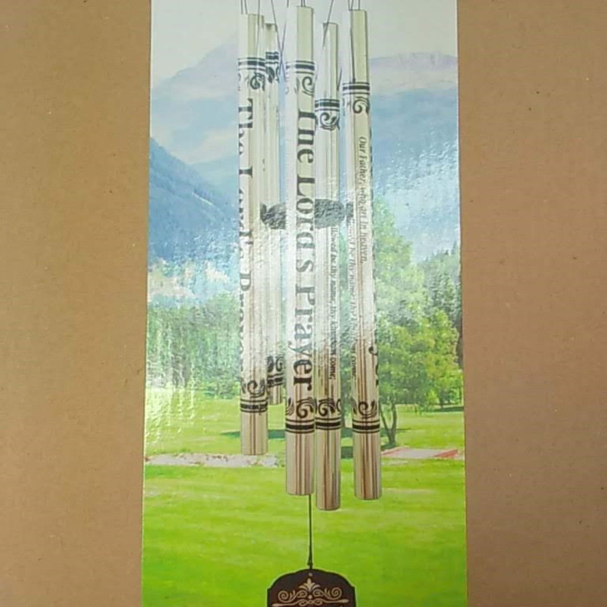 Decorative wind chime with prayer text and hanging metal tubes