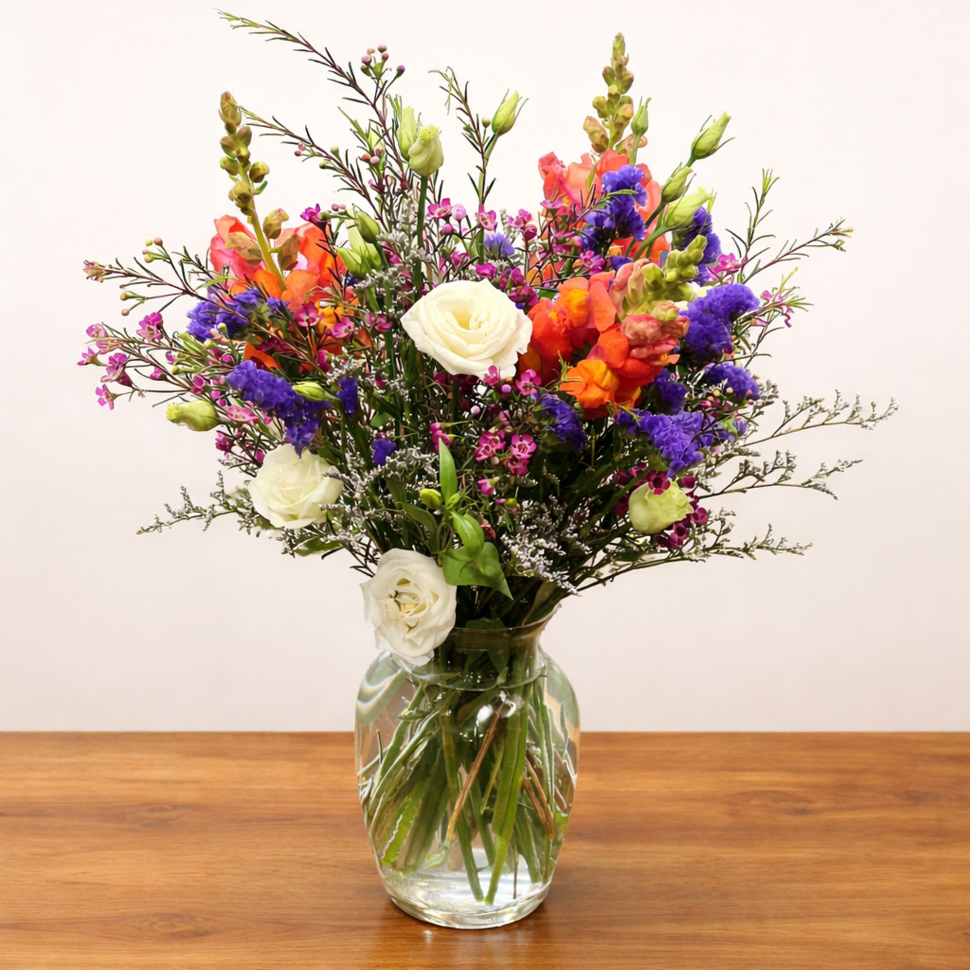 Colorful mixed bouquet in a clear glass vase