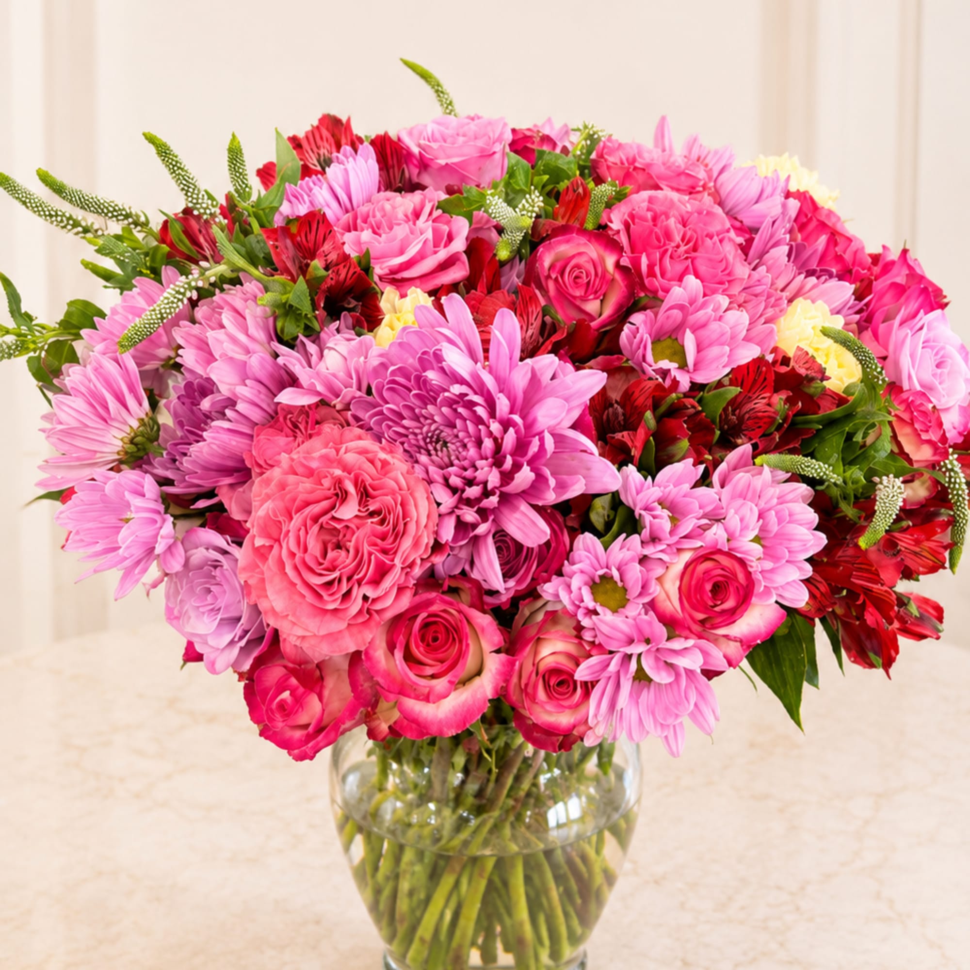 A bright, full bouquet of mixed color blooms that reads as both