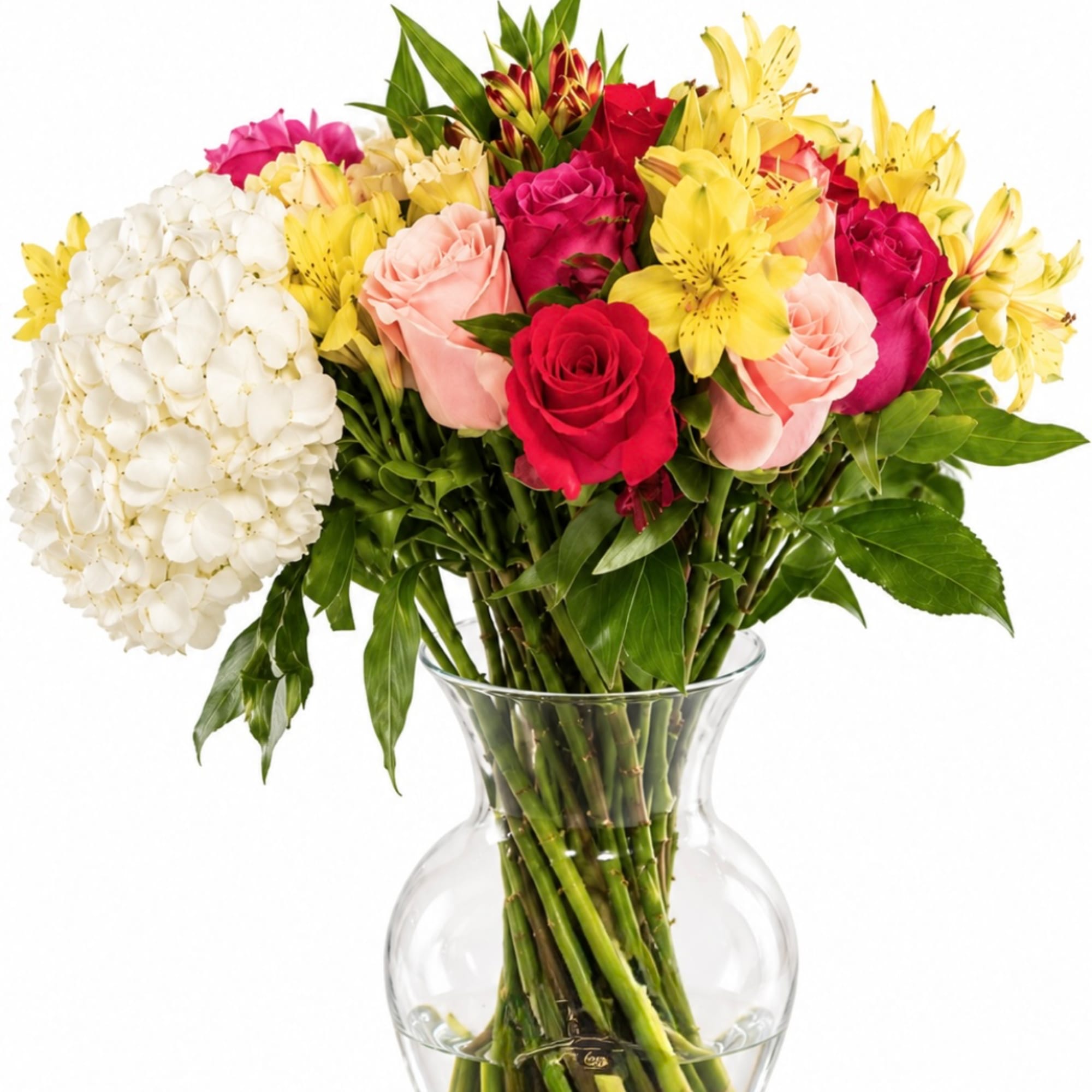 Bouquet of roses, lilies, and white hydrangea in a clear glass vase