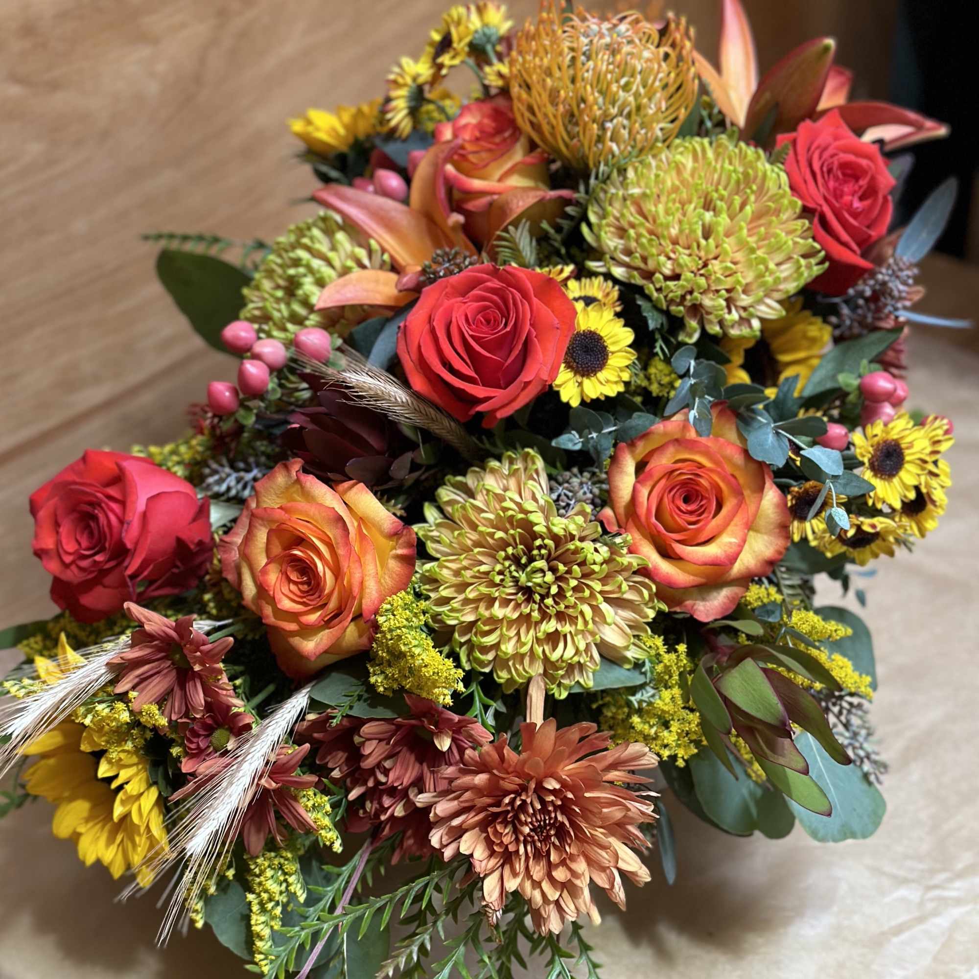 Mixed bouquet with red roses, chrysanthemums, and yellow sunflowers