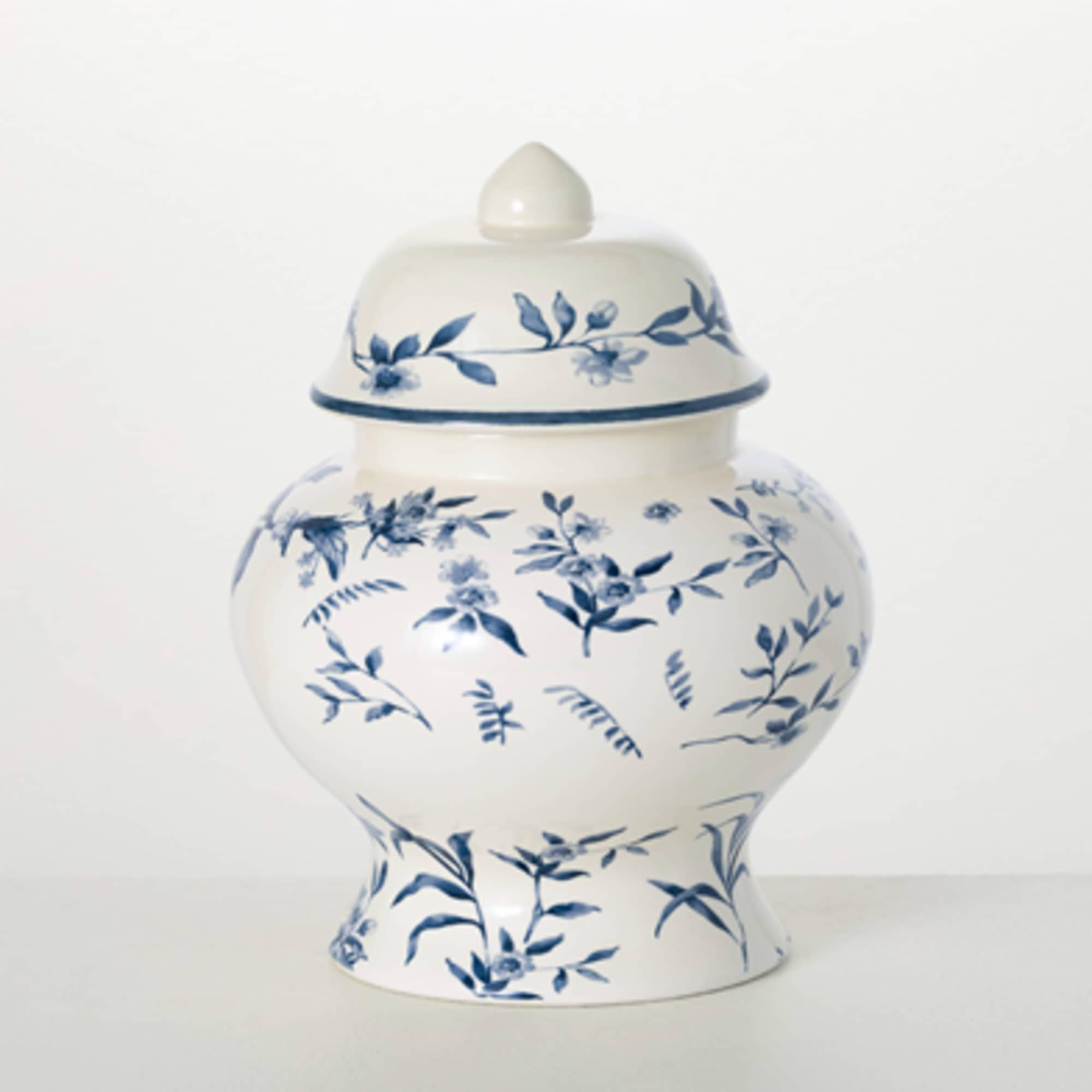 Blue-and-white ceramic urn with a floral pattern and lid