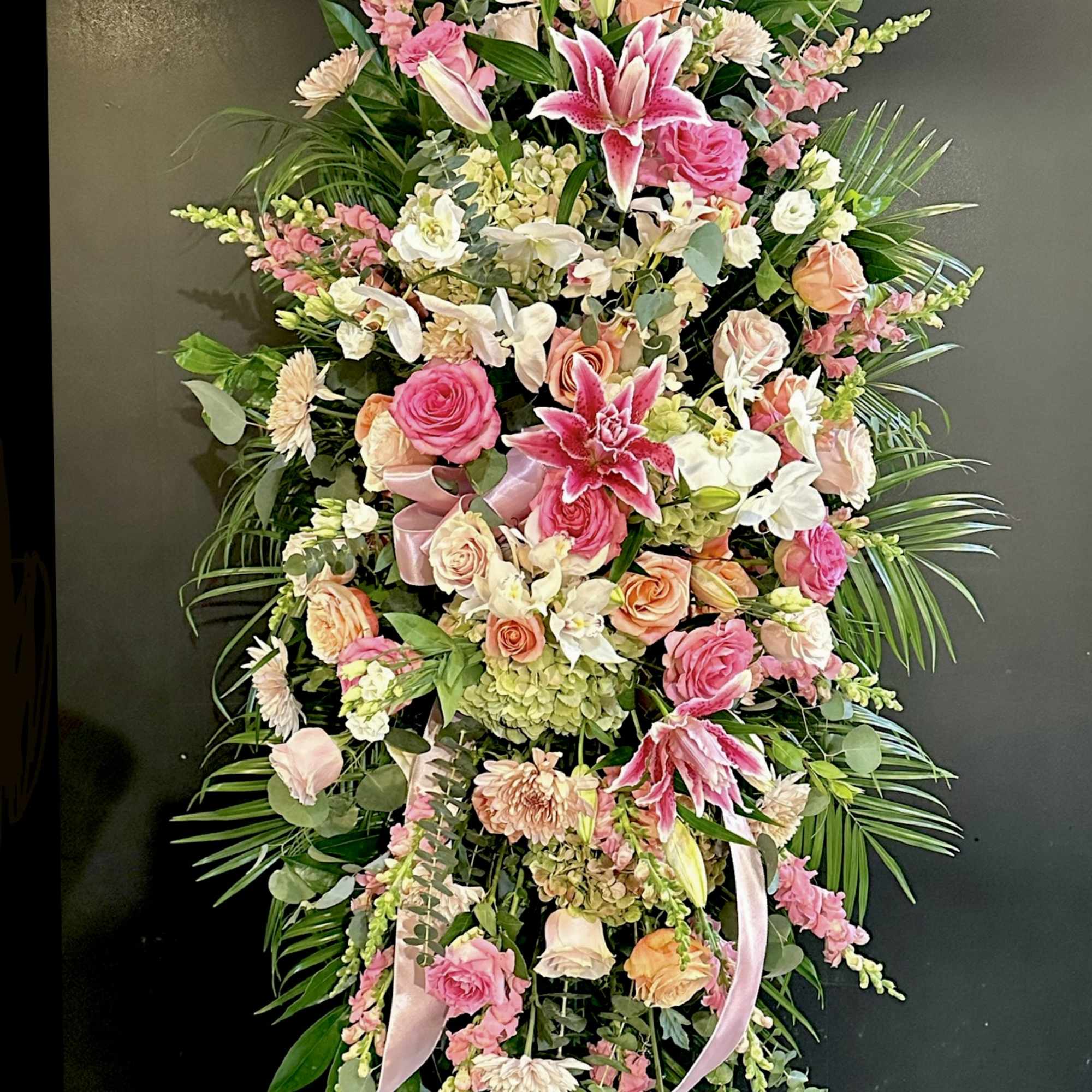 Large pink and white floral standing spray on an easel
