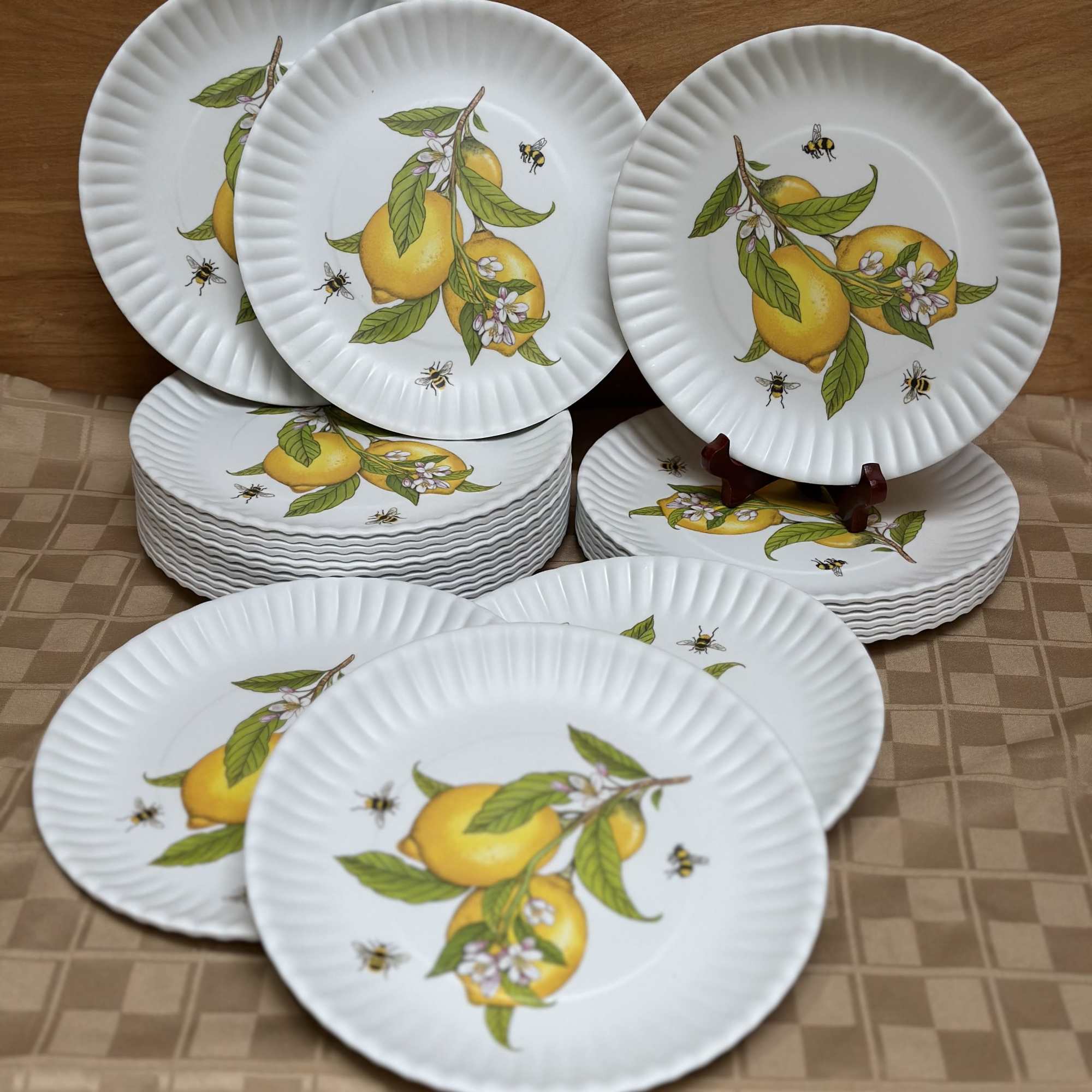Stacked white plates with lemon and bee designs